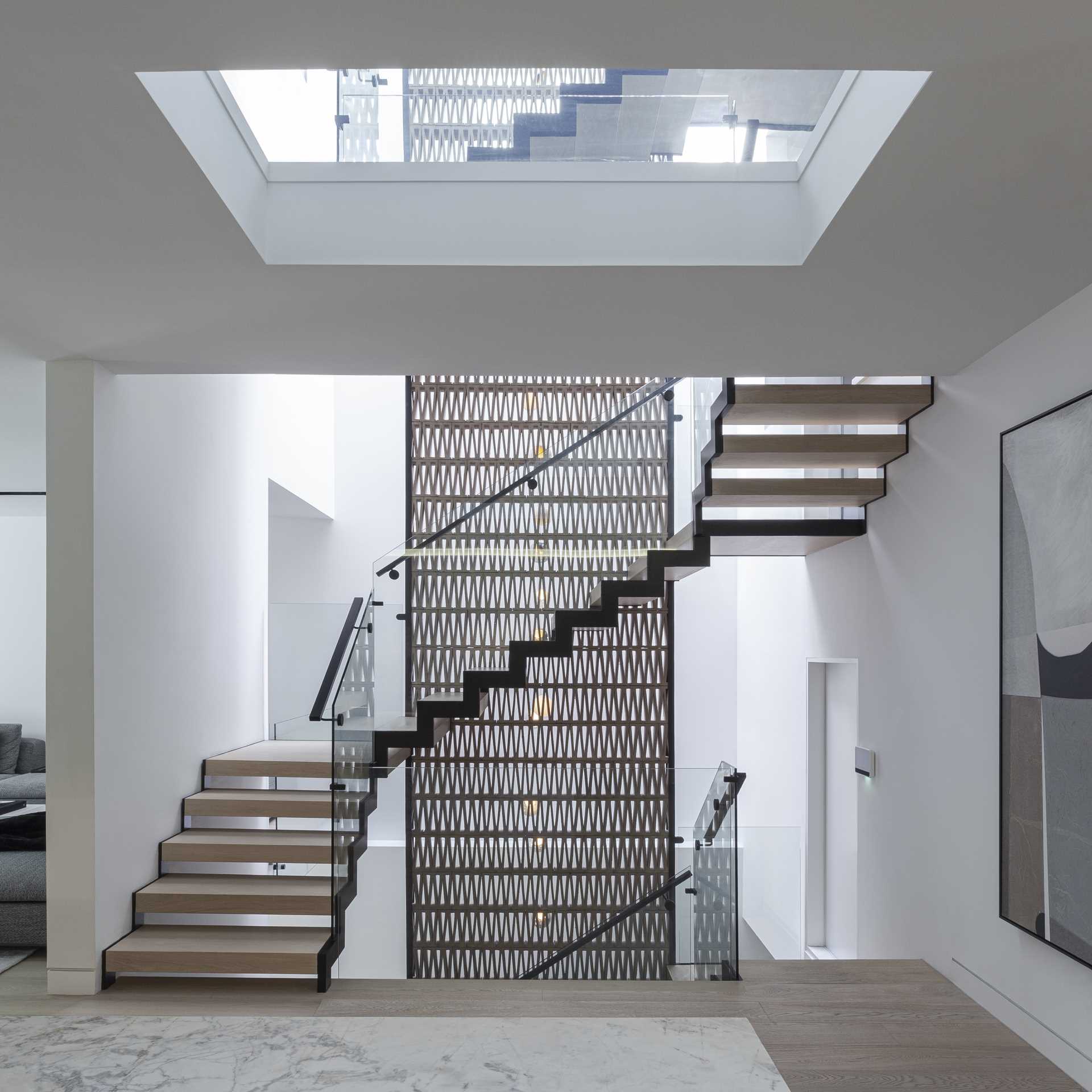 A modern staircase connects the various levels of this modern home.