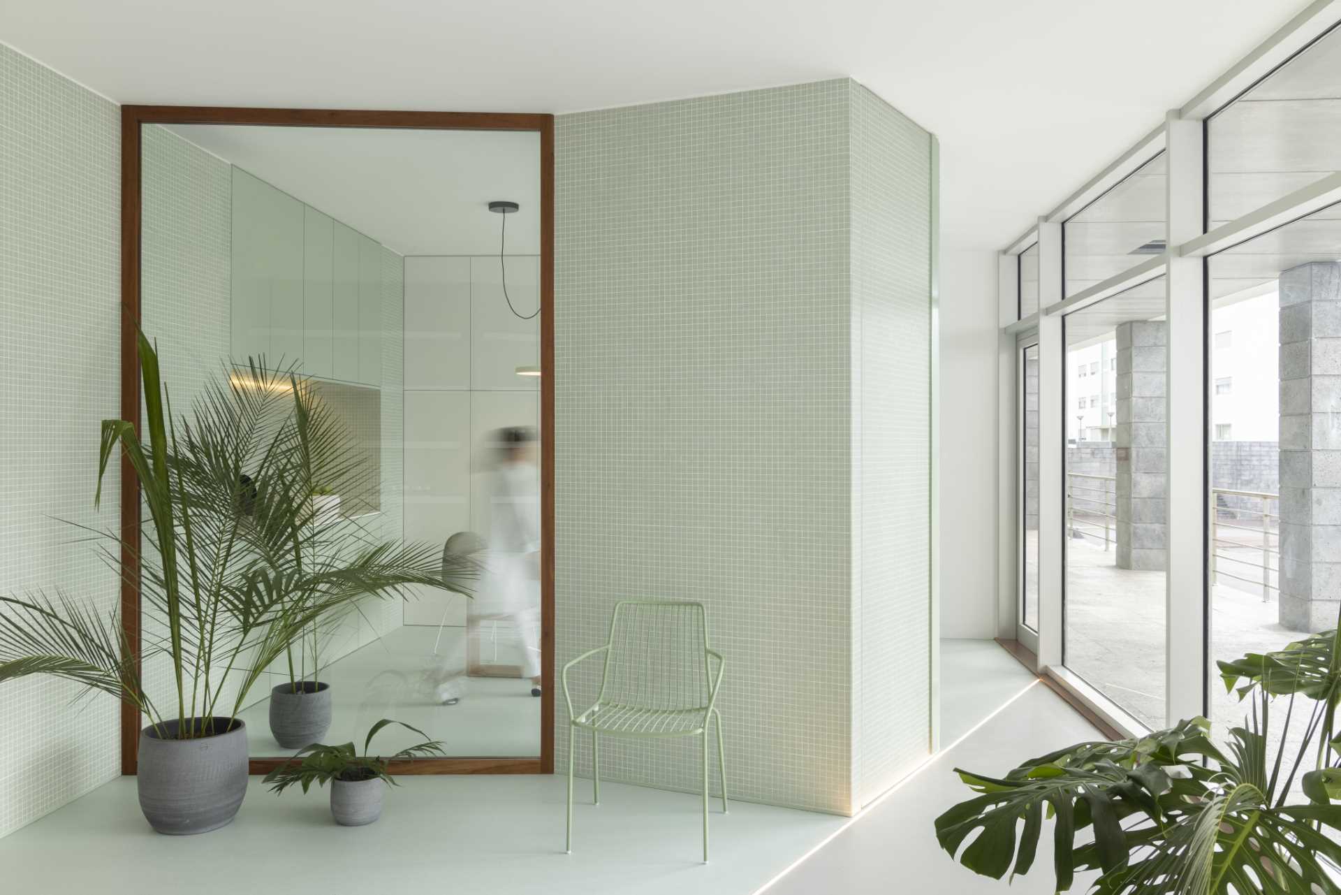 Wood-framed glass walls provide a glimpse into this office and allow the natural light to filter through.