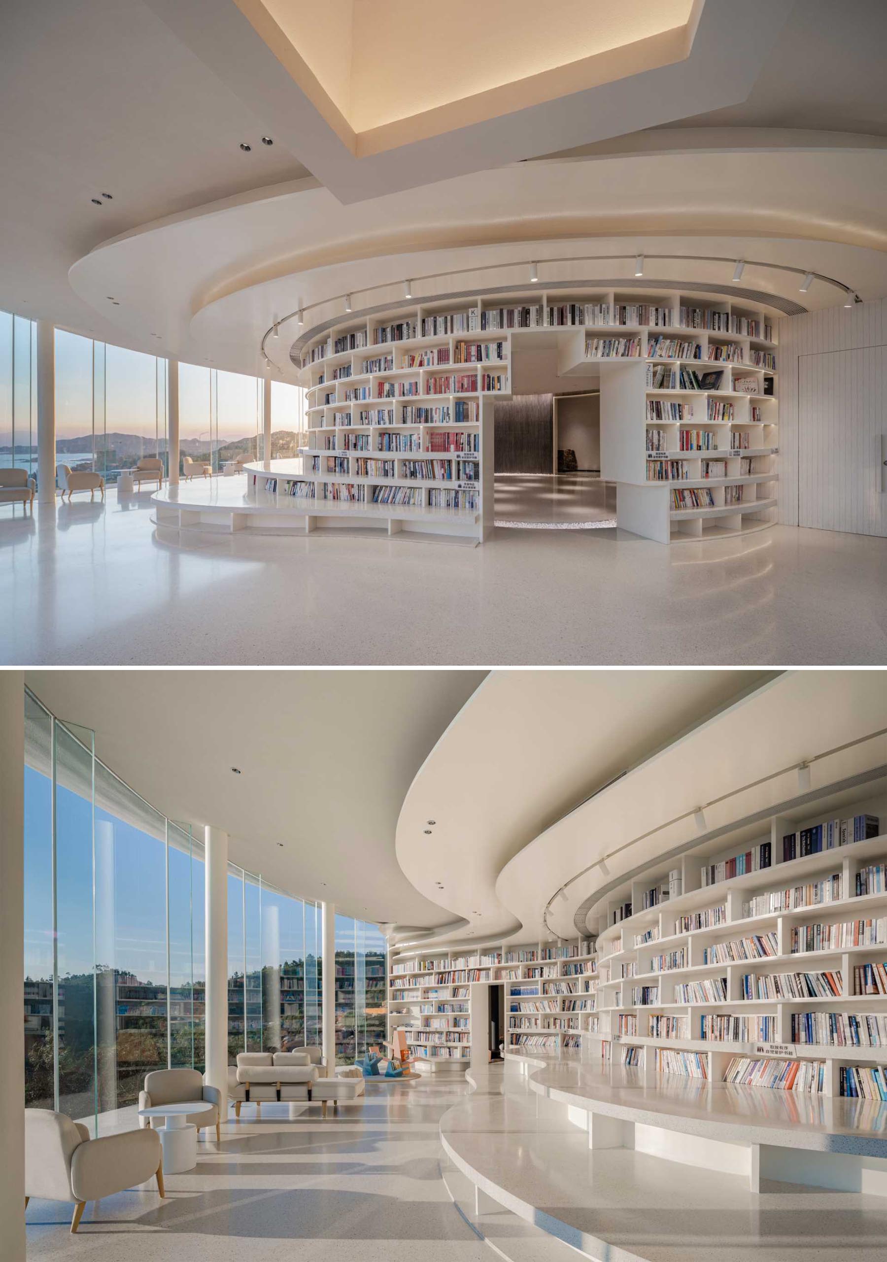 Upon entering this library, guests are welcomed into the reading space, that has a bookshelf that wraps around exterior wall of a dark room, and follows the curves of the building.