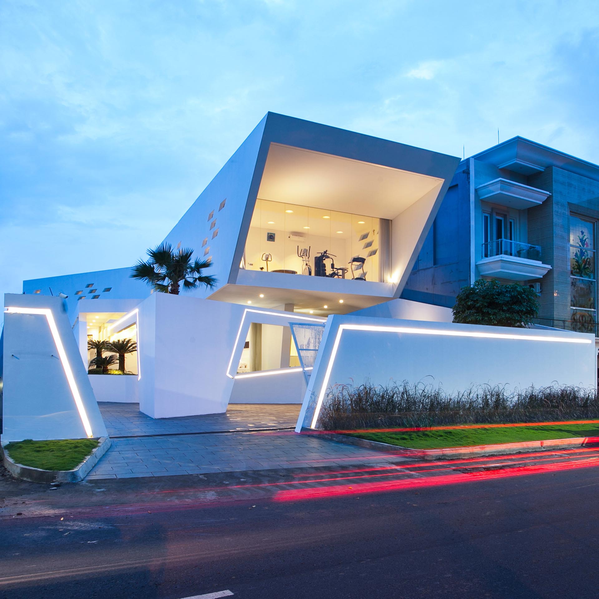 A modern house design with lighting built into the front fence and walls.