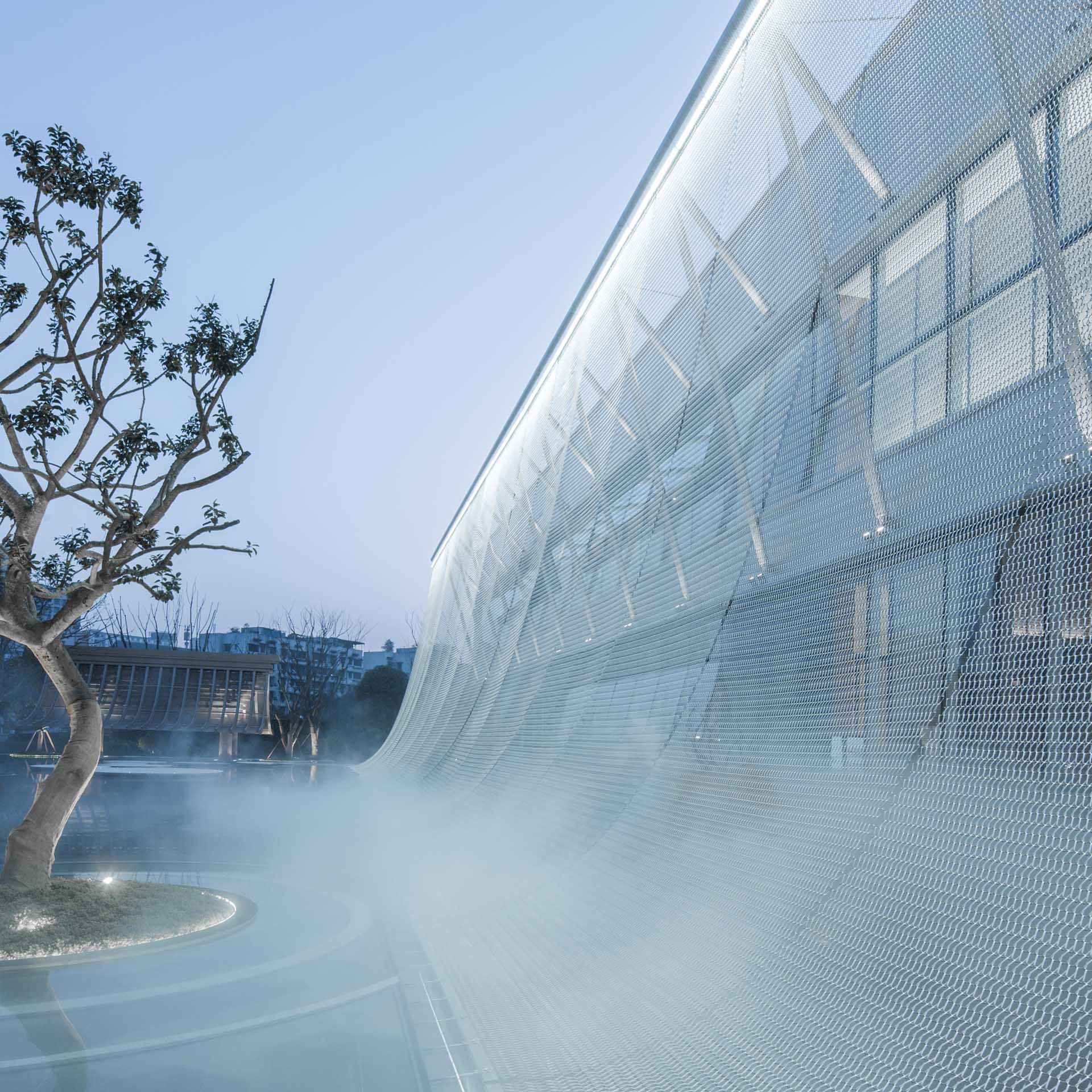 A modern building with a facade that looks like a curtain.