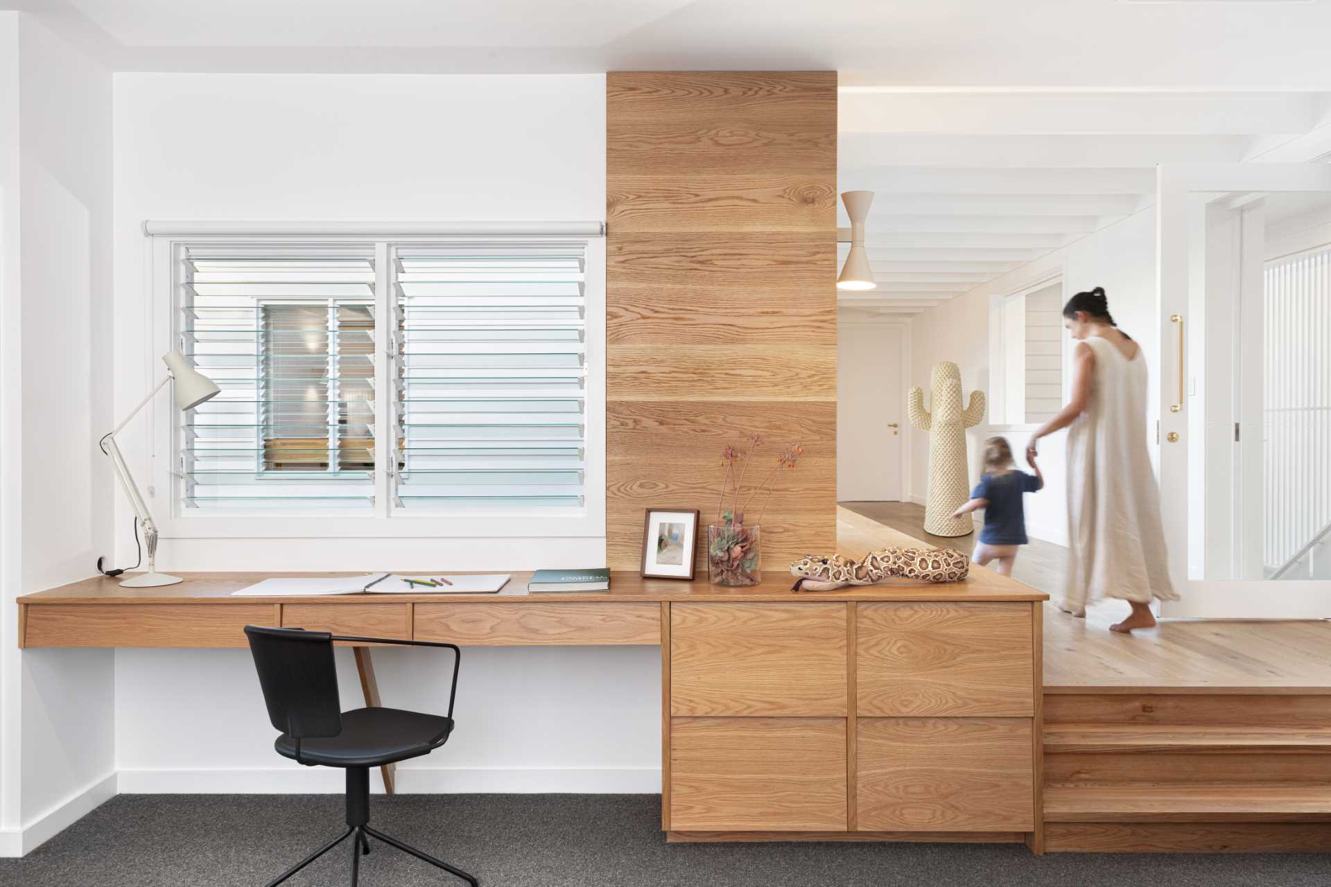 A modern built-in wood desk with plenty of storage.