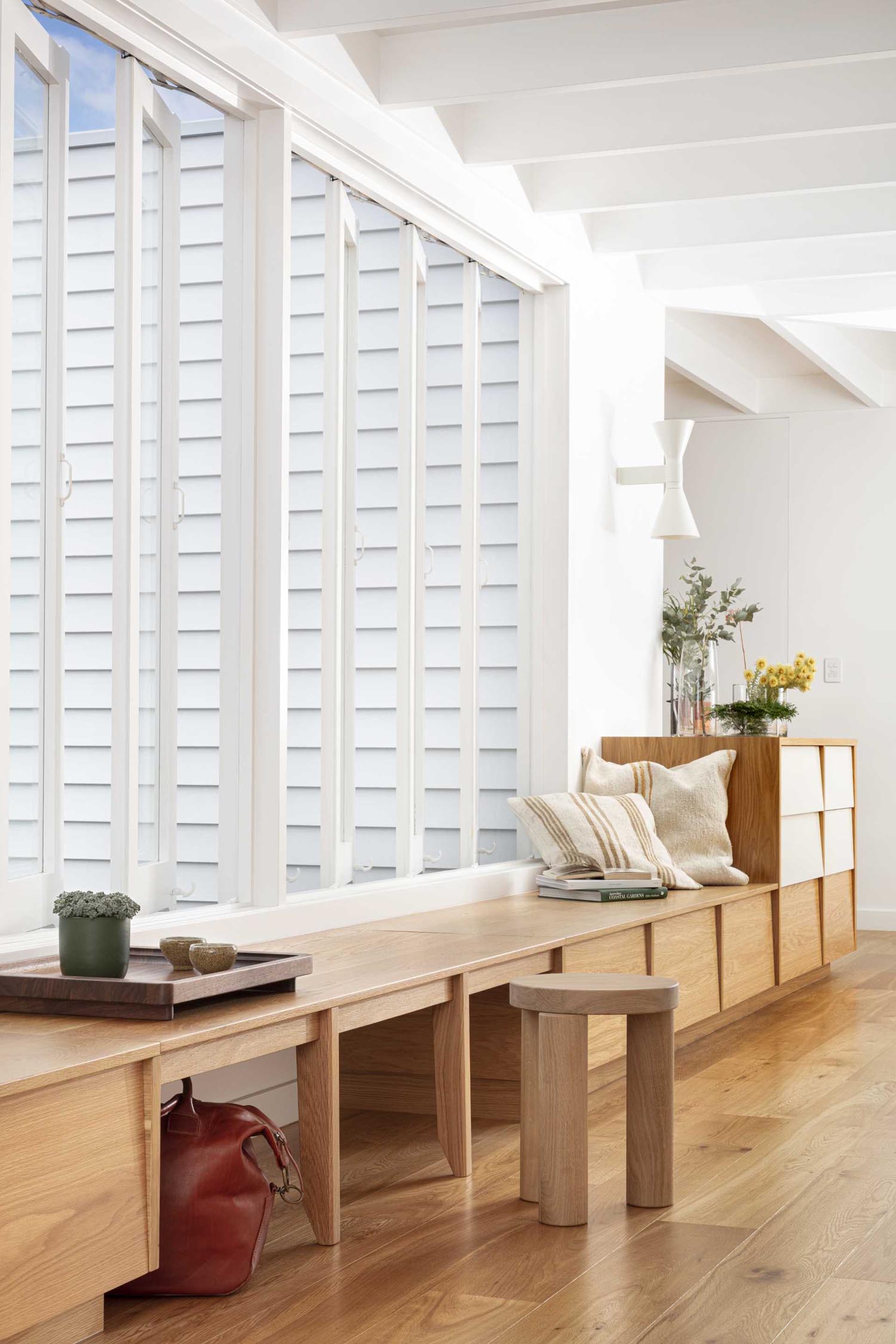 This entryway includes a built-in bench with storage that's located underneath the windows.