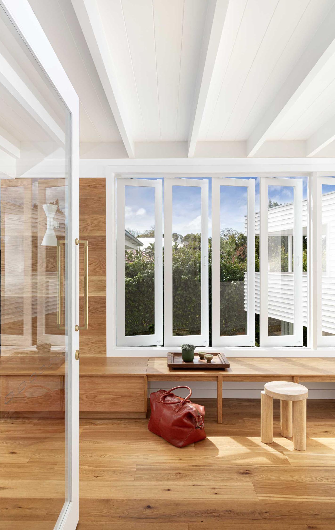 This entryway includes a built-in bench with storage that's located underneath the windows.