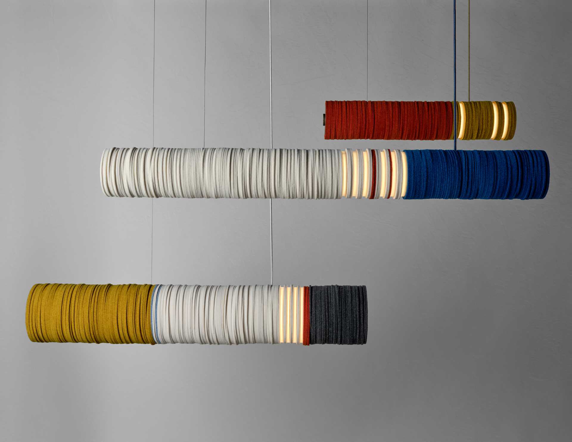 A modern lighting collection inspired by cigarettes and shotgun shell, are made from upcycled felt and aluminum, and energy-saving LEDs.