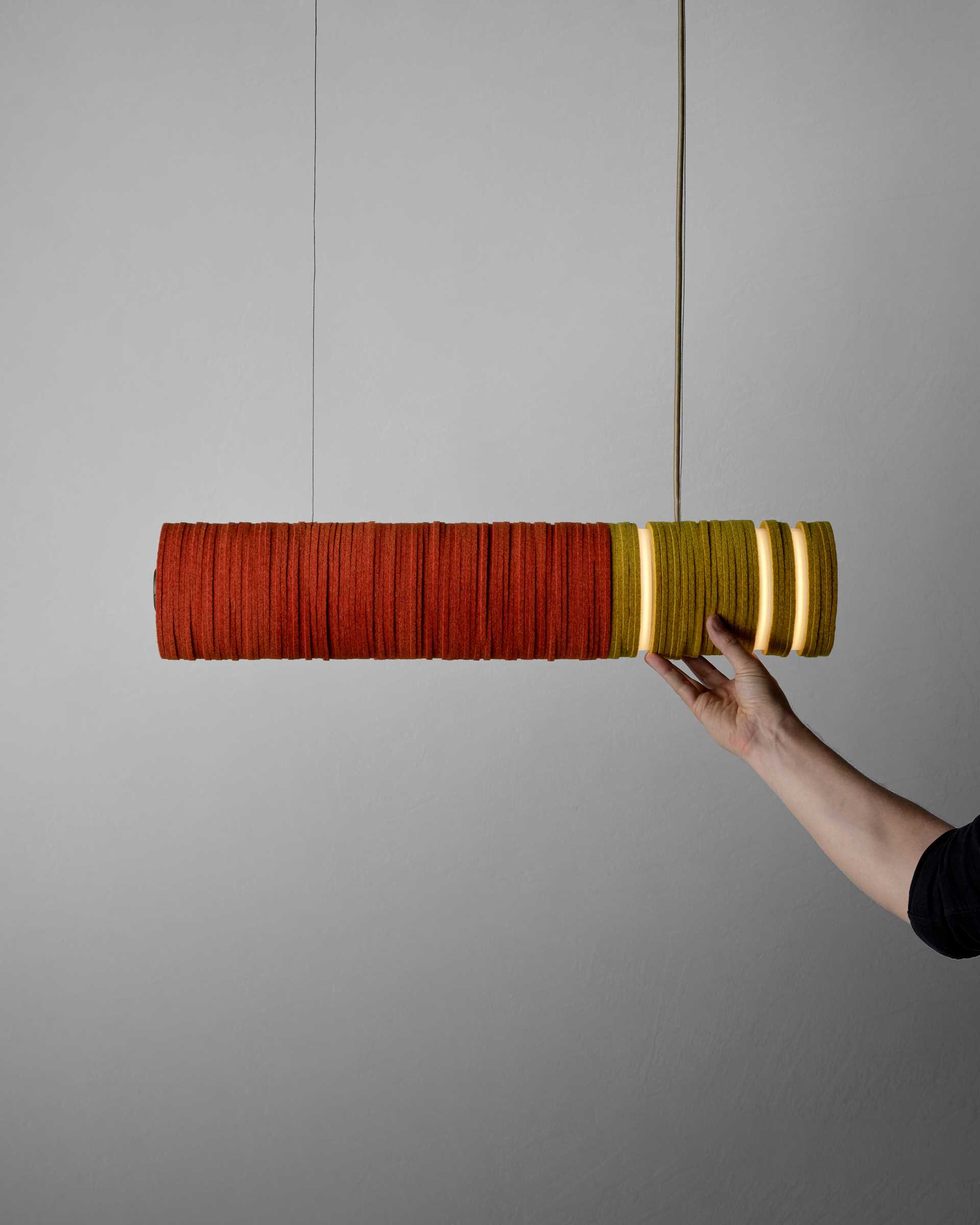 A modern lighting collection inspired by cigarettes, are made from upcycled felt and aluminum, and energy-saving LEDs.