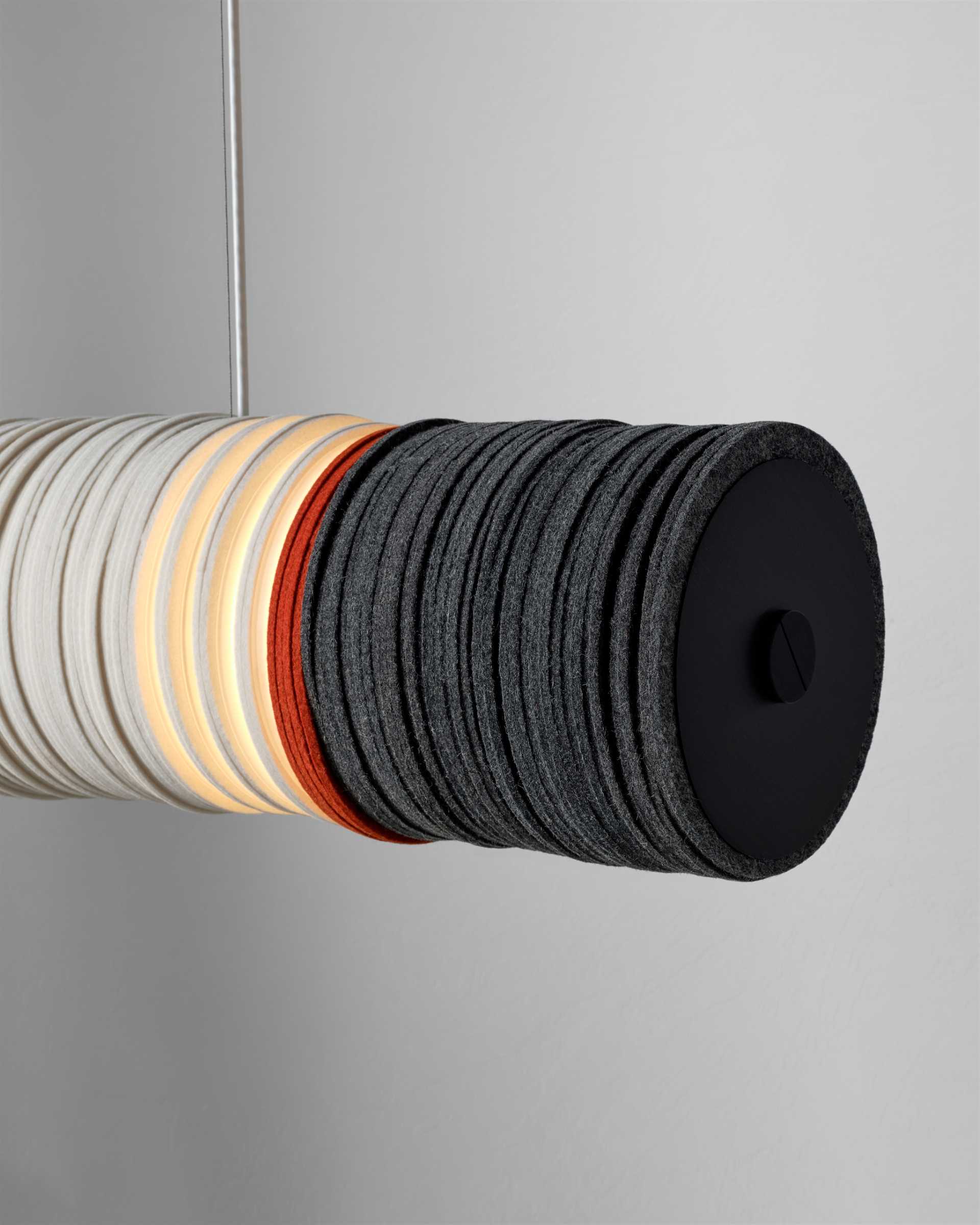 A modern lighting collection inspired by cigarettes, are made from upcycled felt and aluminum, and energy-saving LEDs.