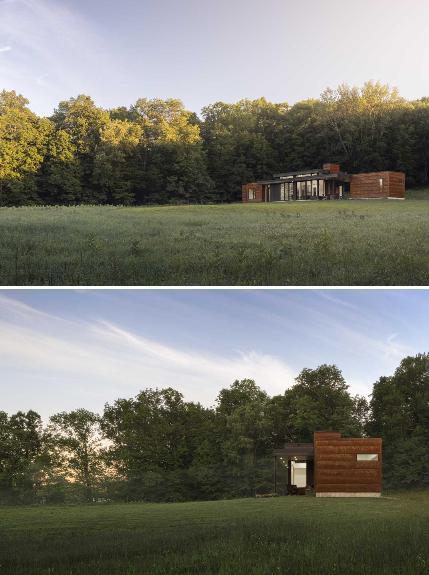 A modern house with a horizontal design, has a weathered steel exterior and black-stained pine siding.