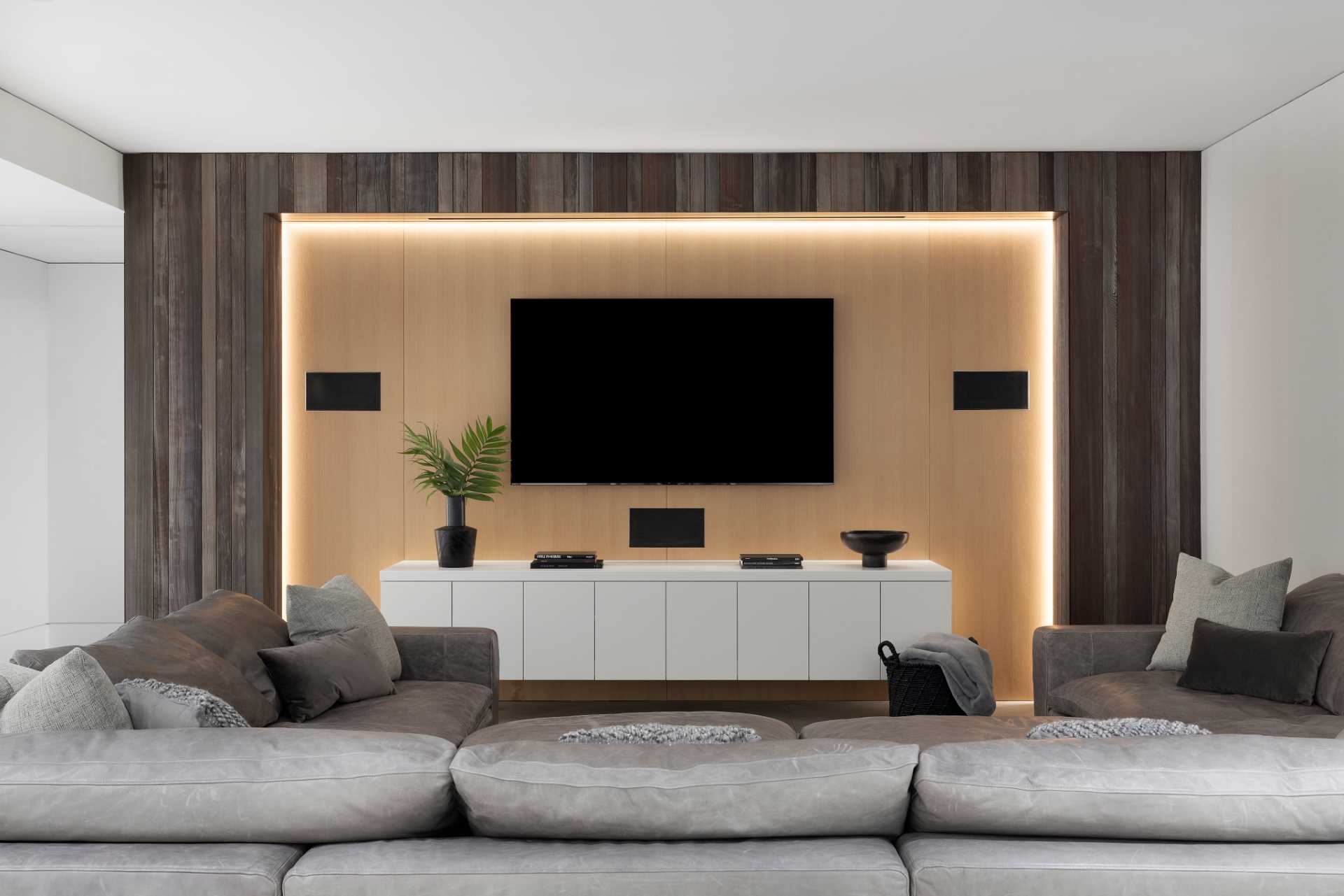 A modern media room with hidden lighting.