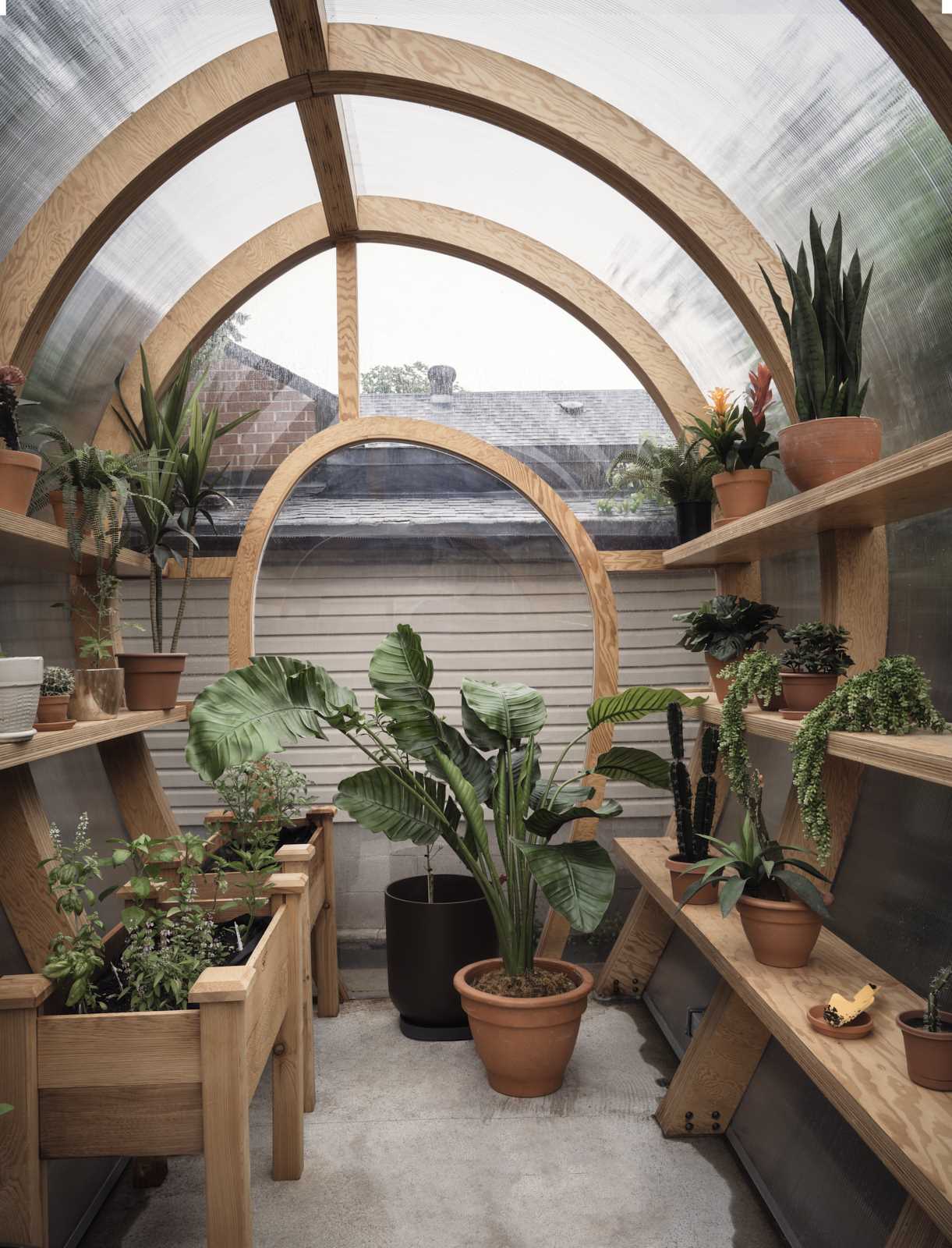 A modern and modular greenhouse design with a curved shape.