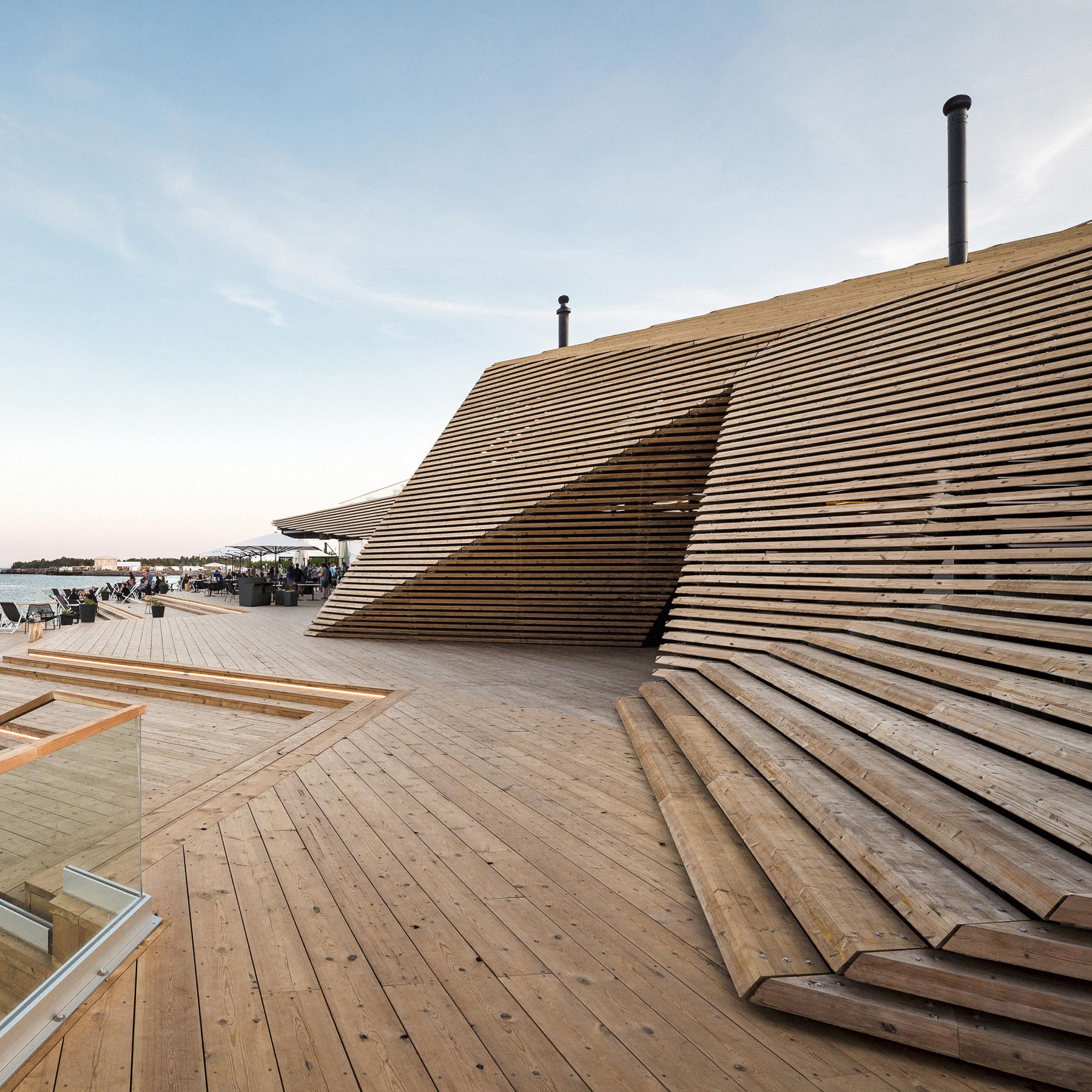 A modern public sauna and restaurant with a wood design.