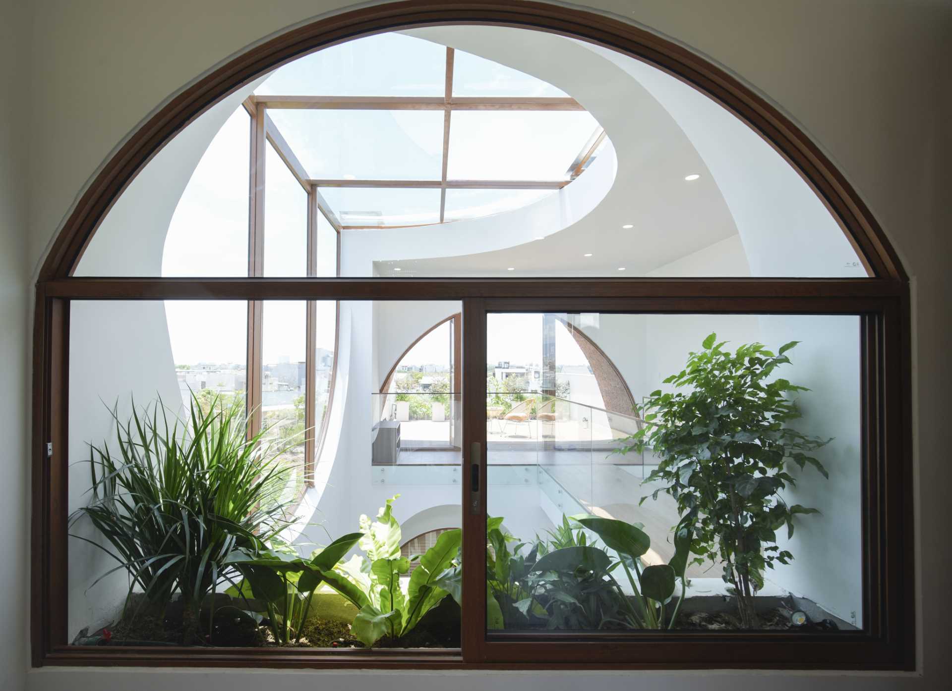 A modern house with an arched window and built-in planter.