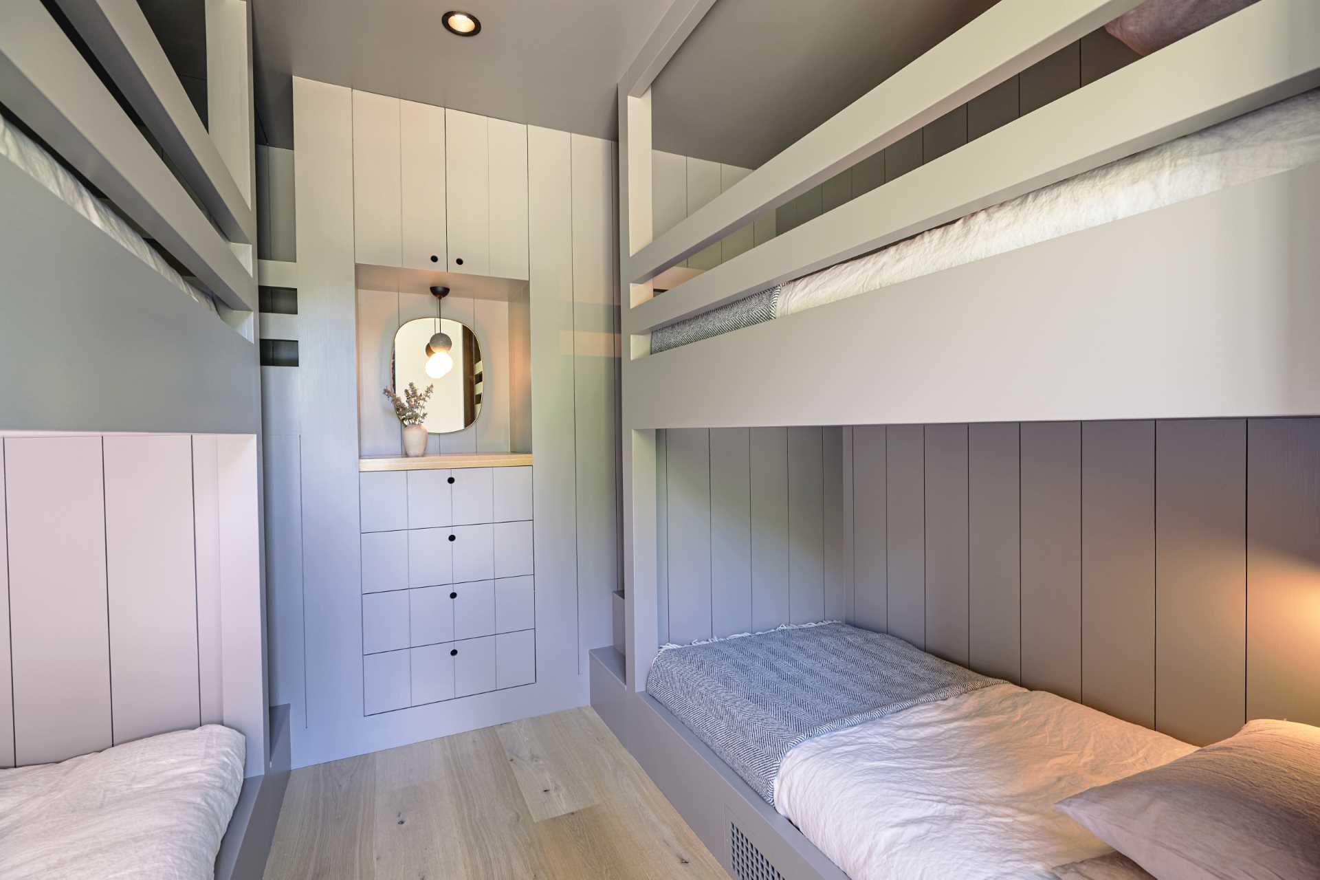 A modern bedroom with multiple bunk beds.
