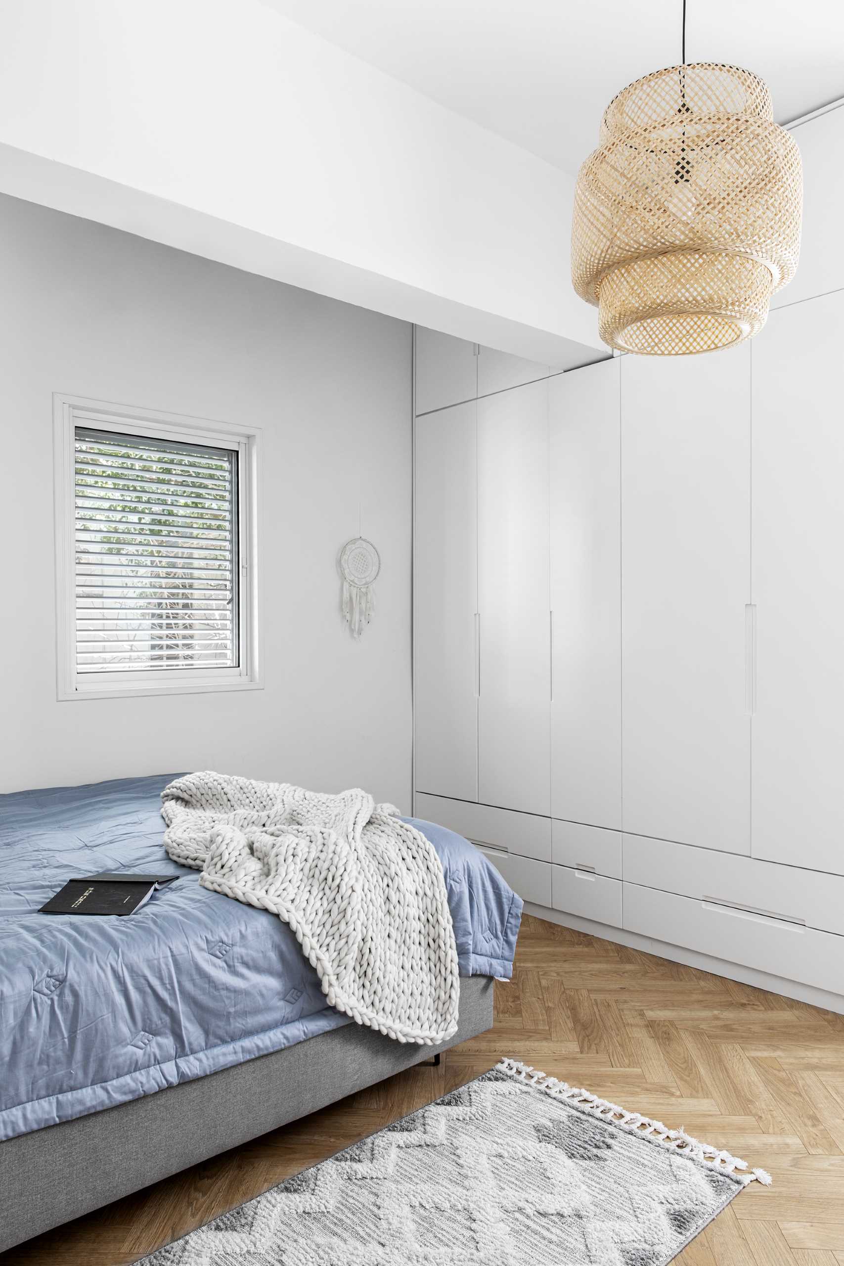 In this modern bedroom, there's floor-to-ceiling closets.