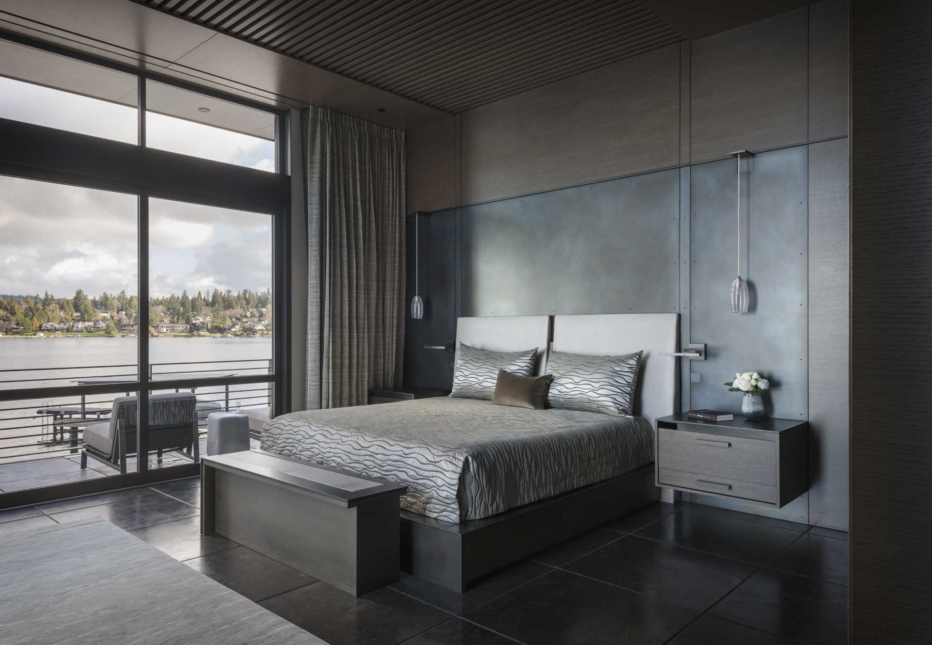 In this modern bedroom, a steel and wood accent wall acts as a backdrop for the bed.