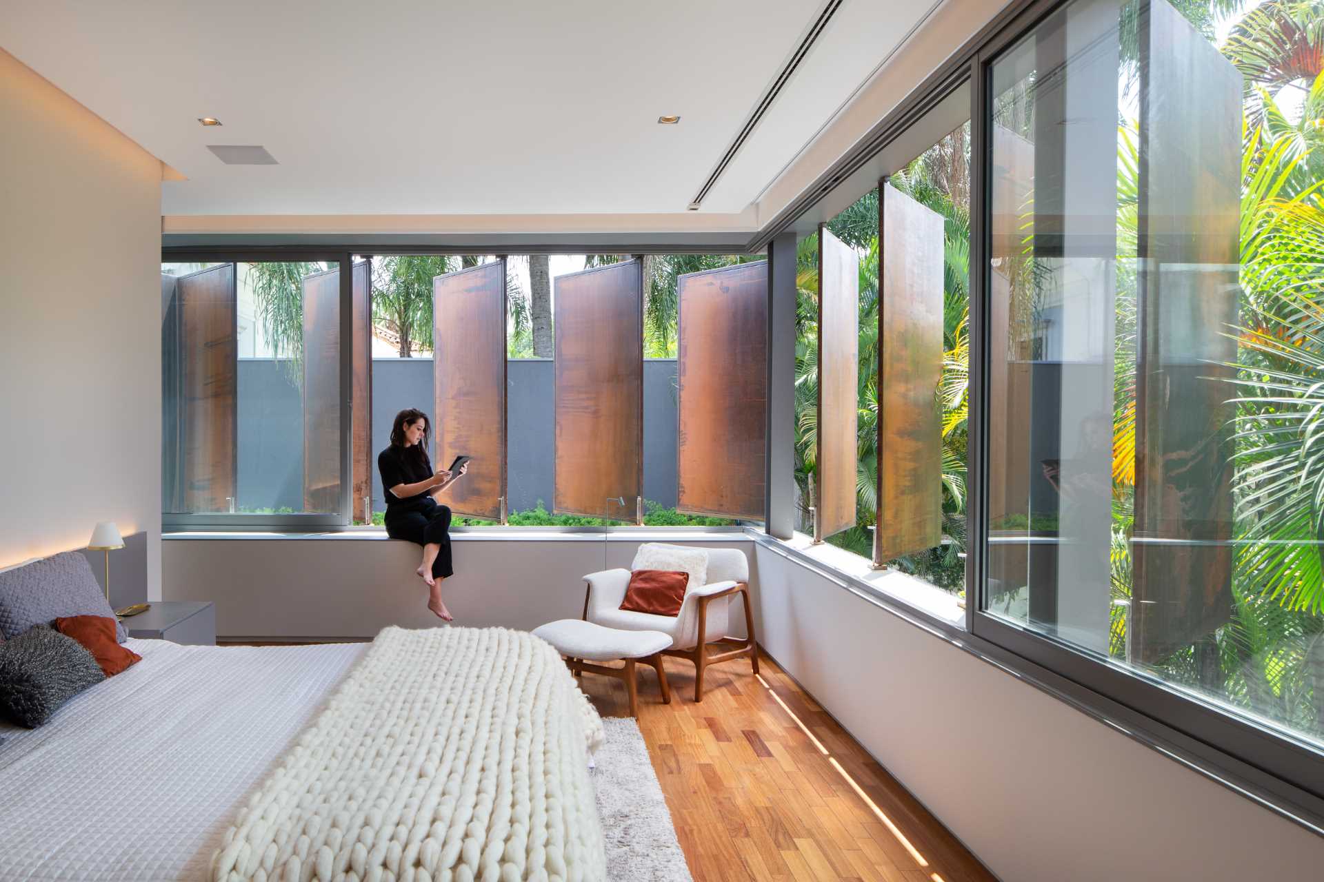 Large metal shutters provide privacy for the primary bedroom.