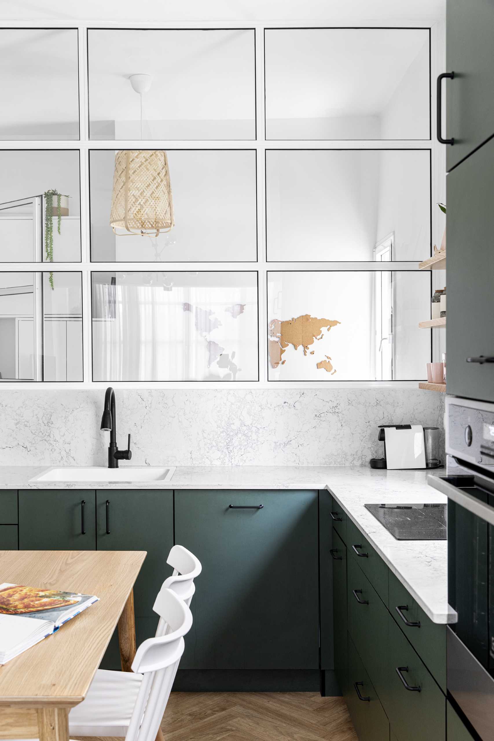 White-framed windows in the kitchen provide a view of the home office.