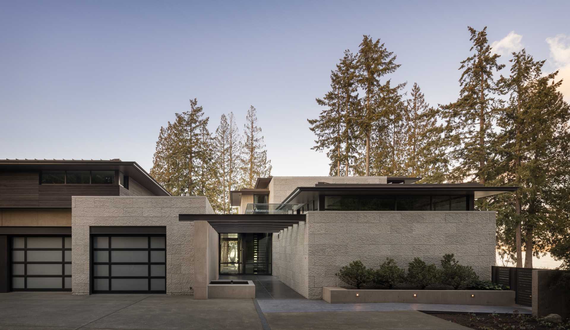 A modern house with a water feature that guides you to the front door.