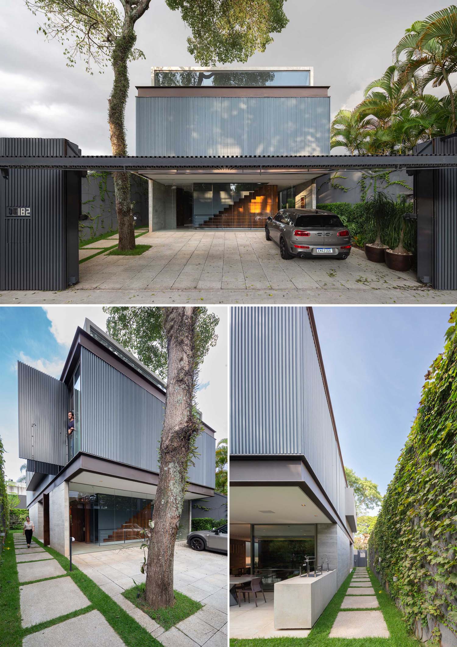 The front of this modern house showcases an upper level that's encased in metal, adding privacy to the home.