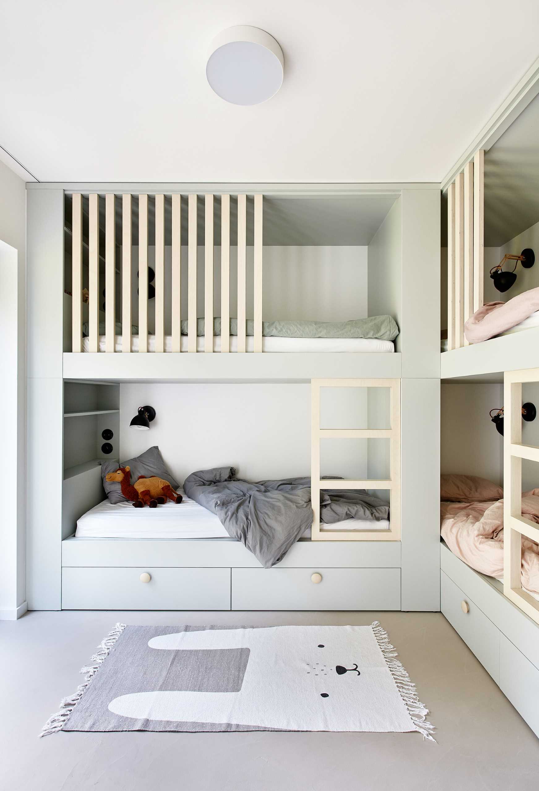 There's multiple built-in bunk beds that have been included in a bedroom for the children.