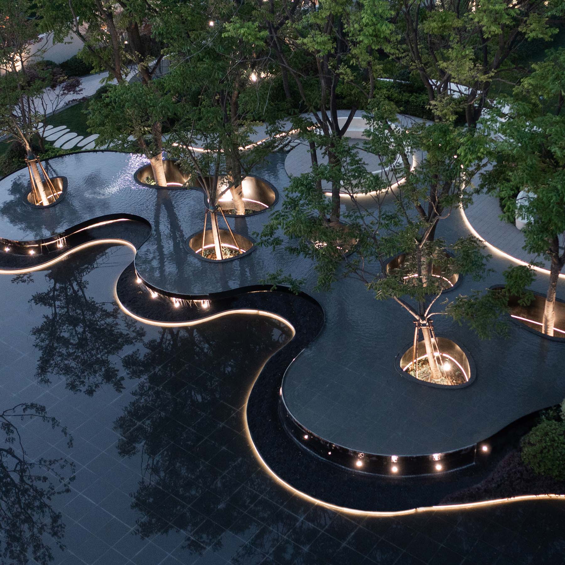 A modern landscape design that uses lighting to highlight curves.