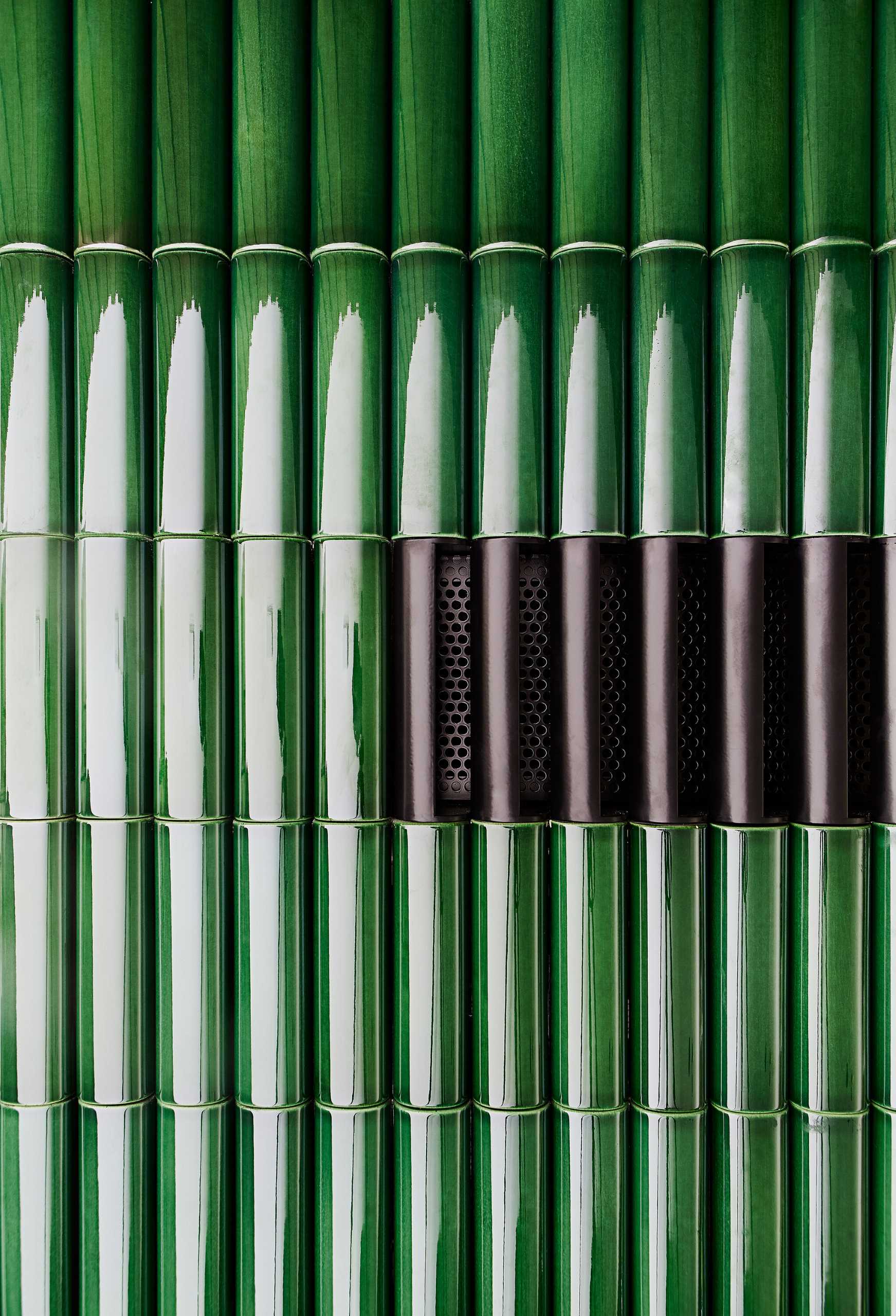 Rounded green tiles cover the exterior of a fireplace.