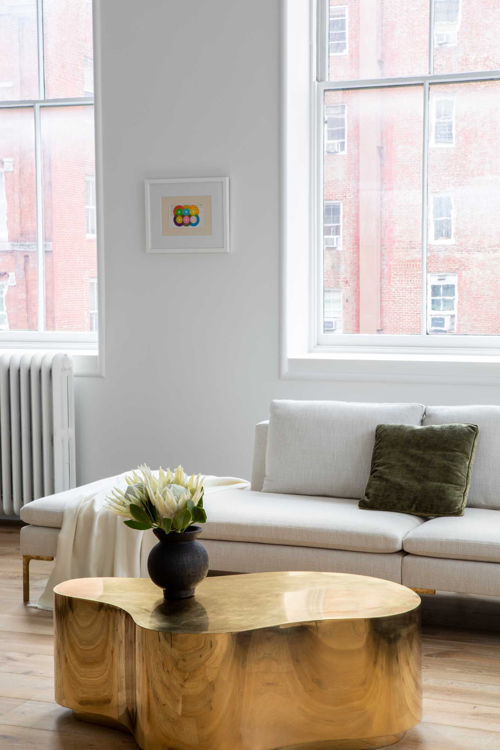 A modern living room with wide plan oak flooring.