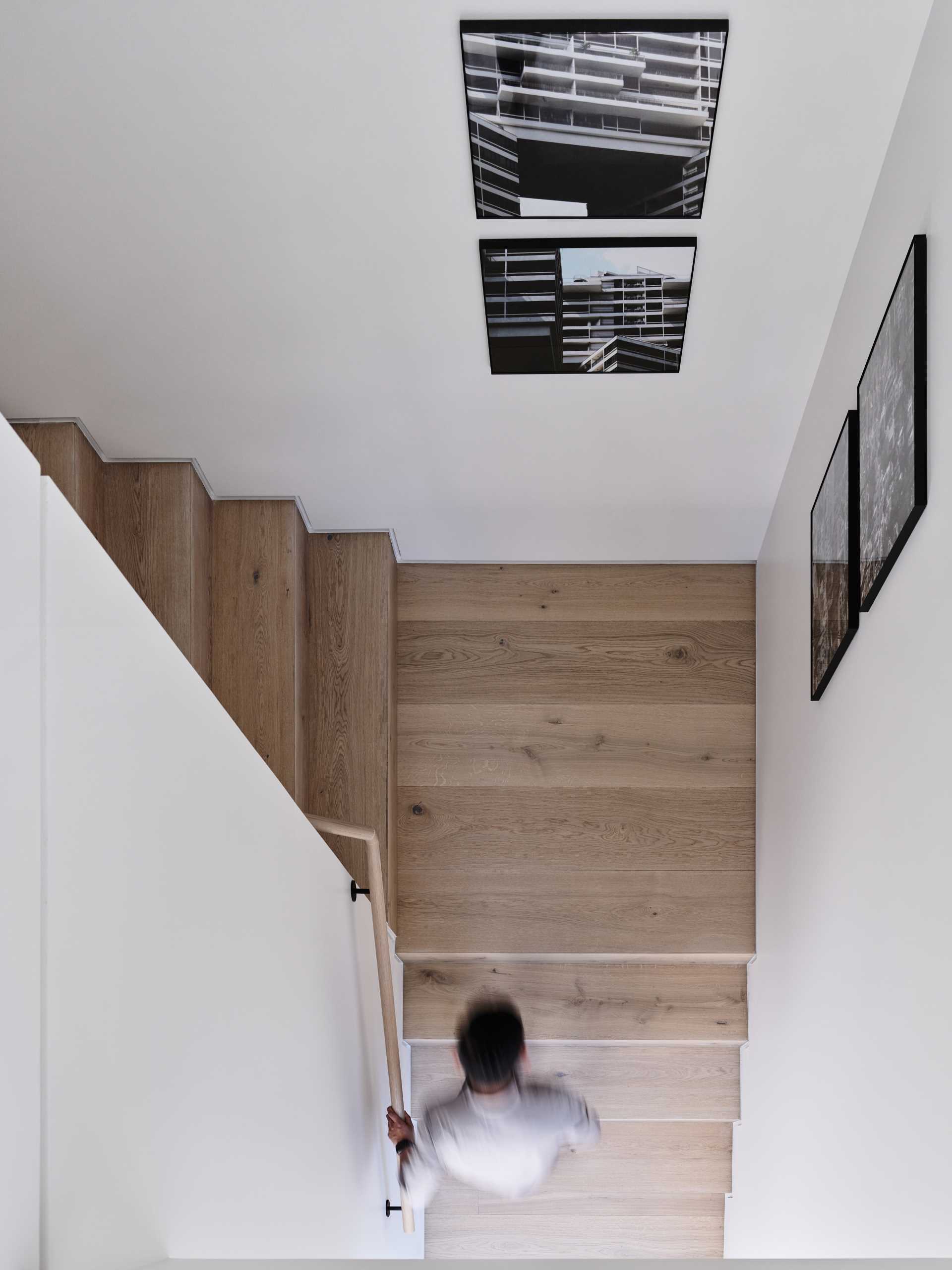 A modern interior with wood stairs.