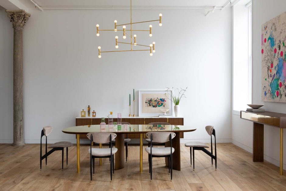 A Large Mirrored Wall Is A Prominent Feature Of This Apartment An ...