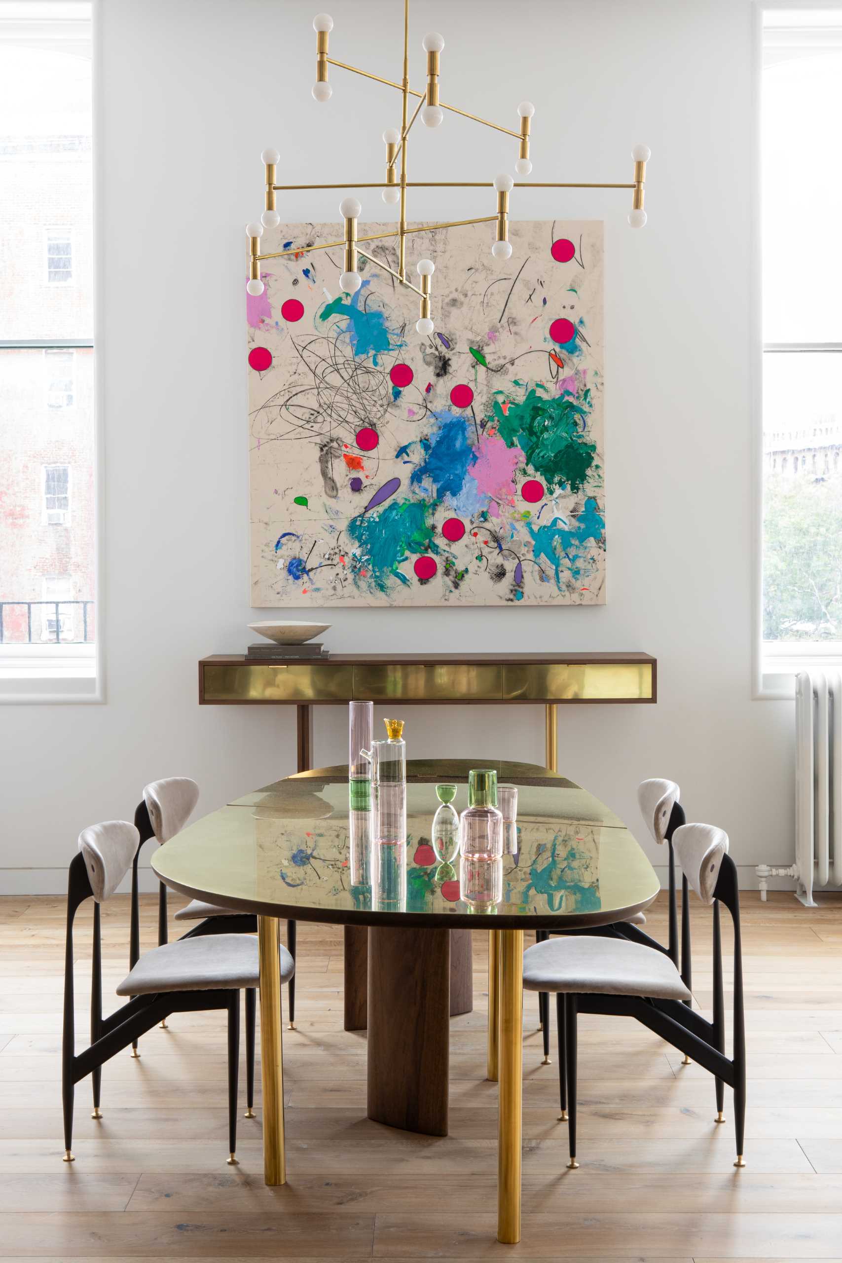 An open plan dining room with custom furniture pieces and a Dot Atomium Chandelier by Lambert & Fils.