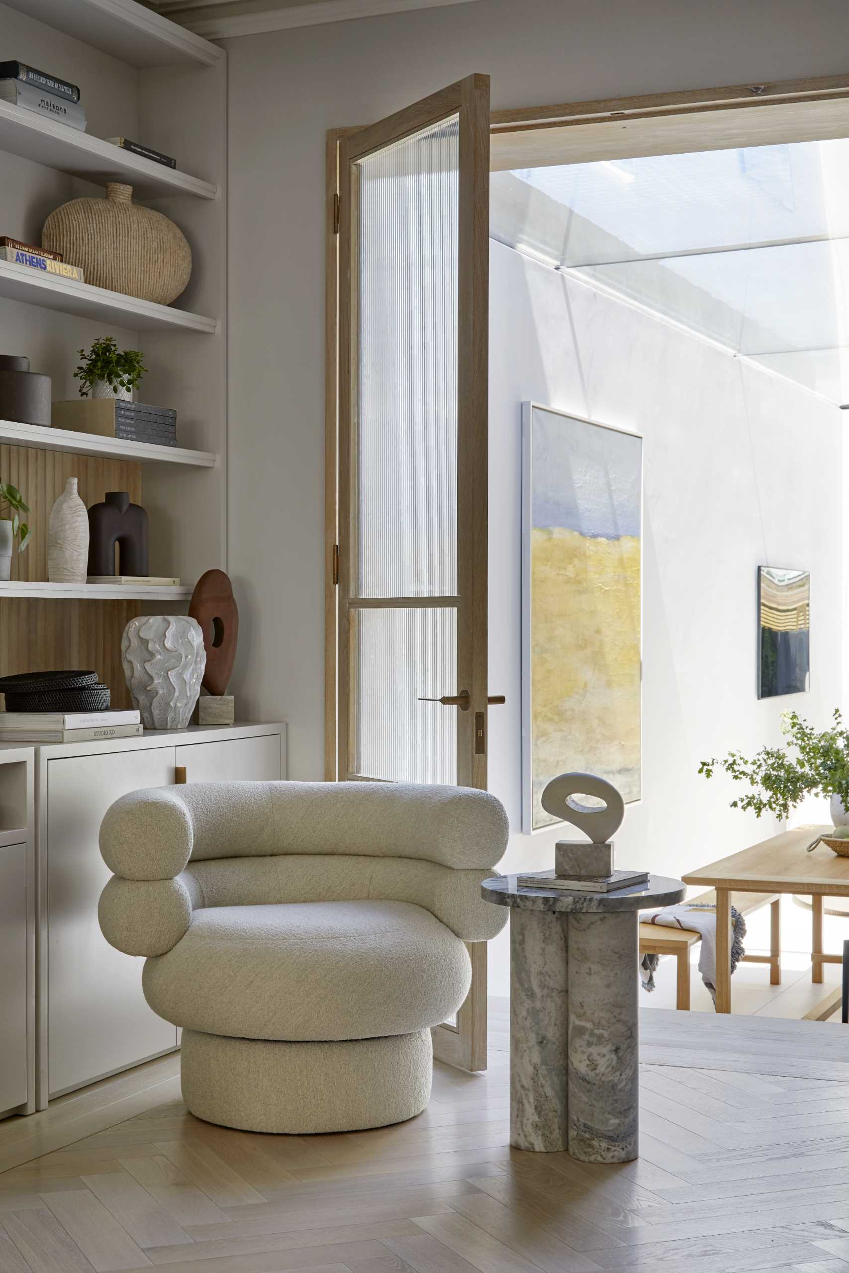 A contemporary living room with built-in bookshelves and cabinets.