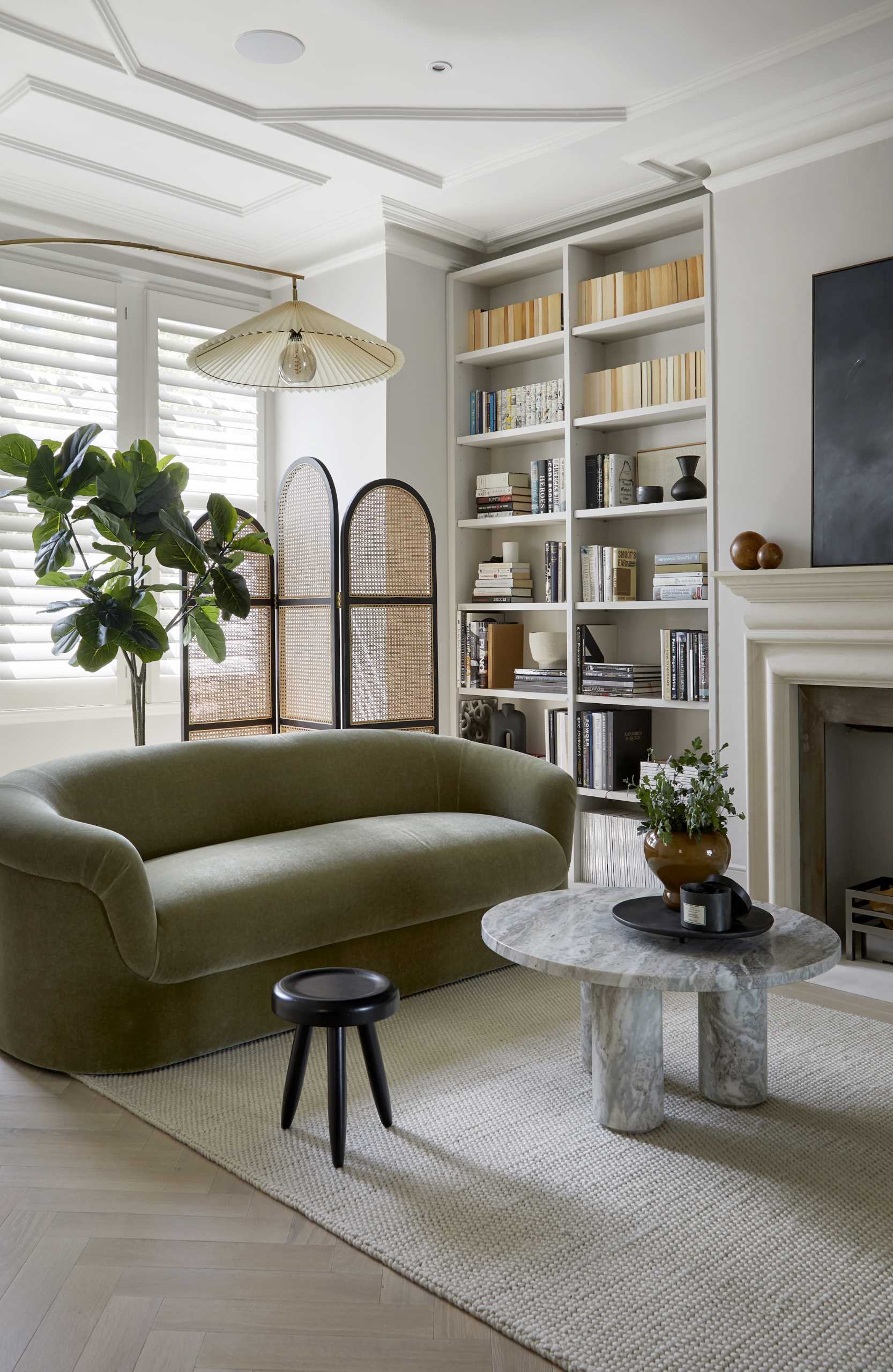 A contemporary living room with comfortable furniture and built-in bookshelves.