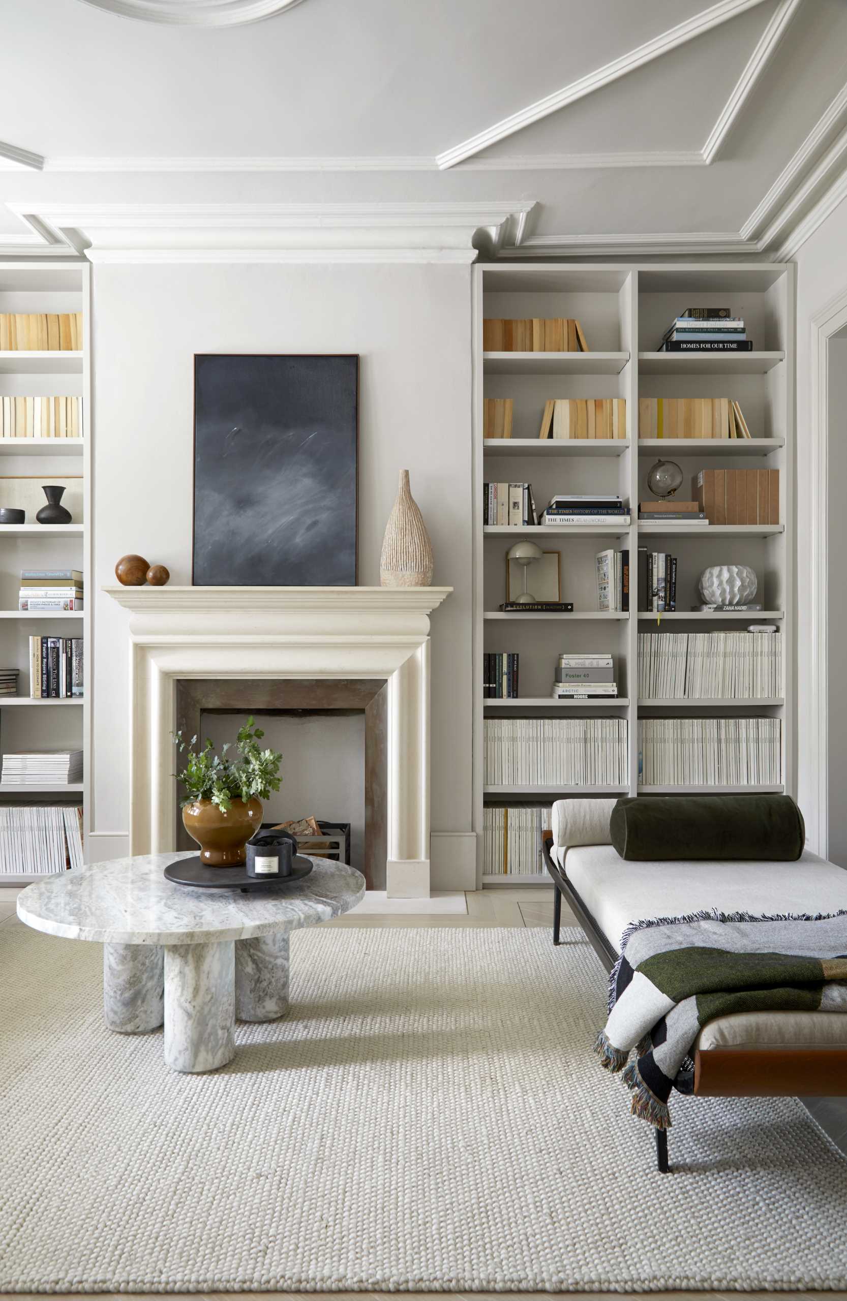 A contemporary living room with built-in shelves and cabinets.