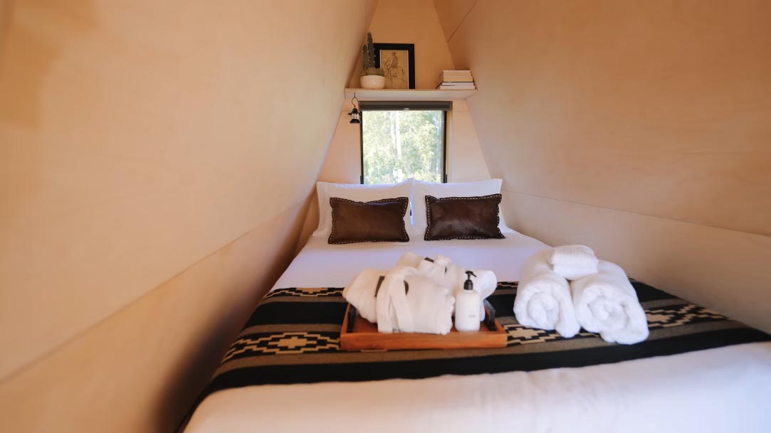 A small bedroom in an a-frame cabin.