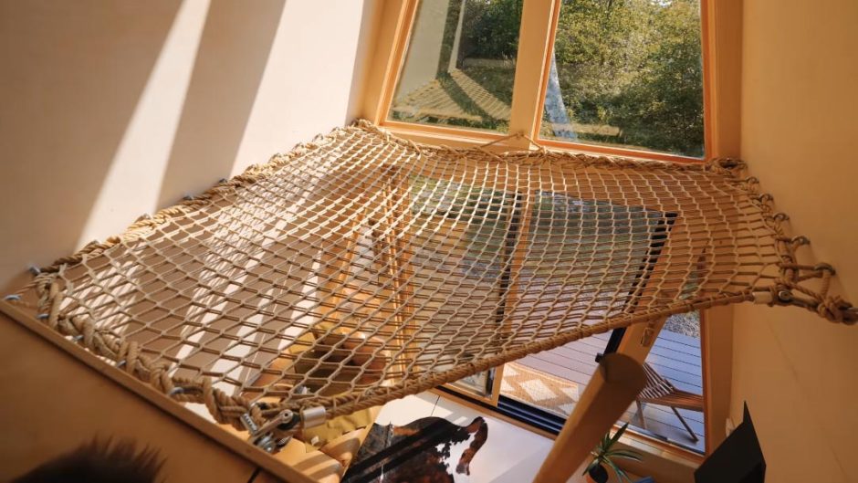 A Net Loft Is Made Possible From The High Ceiling Inside This A-Frame Cabin