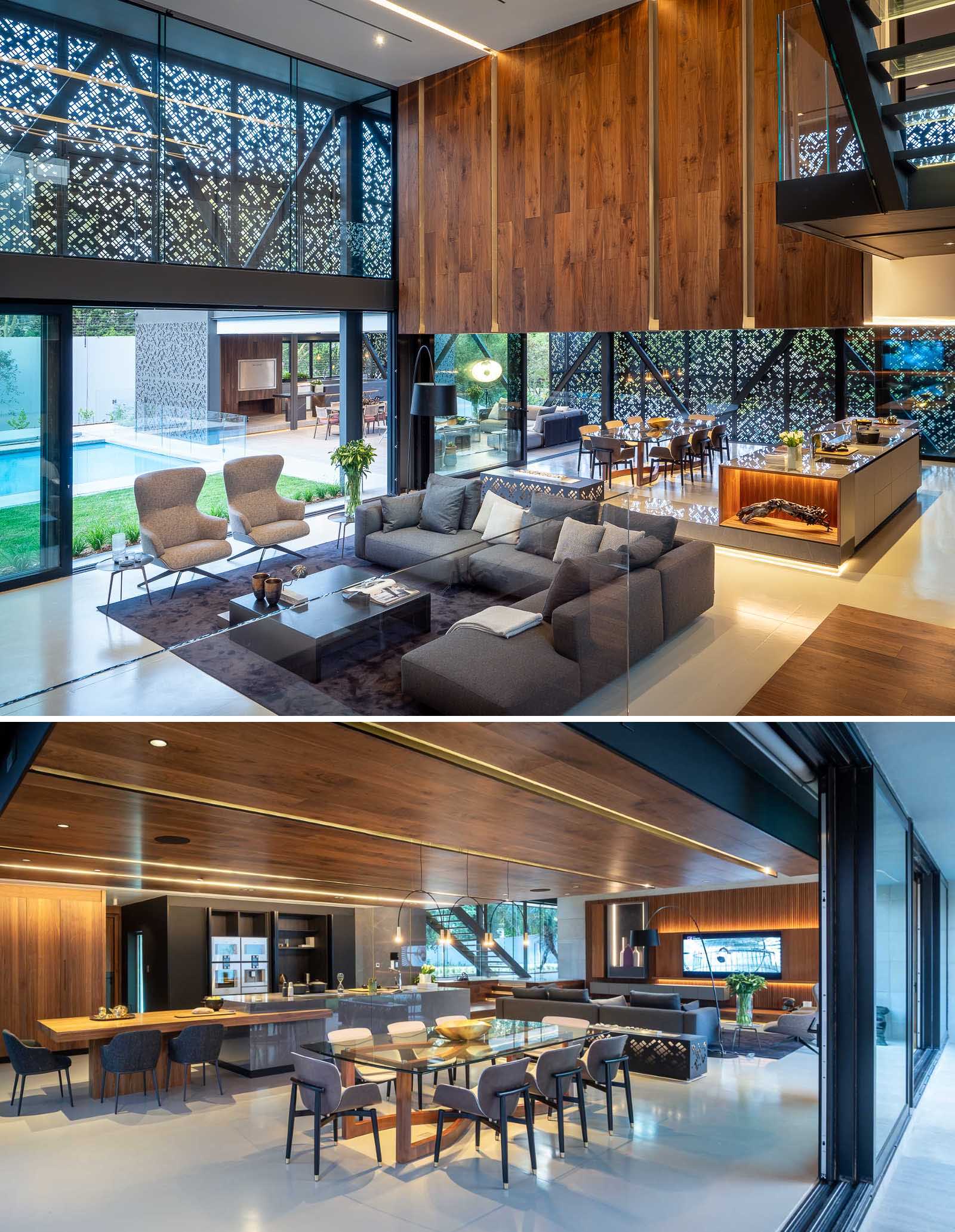 The interior of this modern home includes an open floor plan for the social areas, like the family room, dining area, and kitchen.