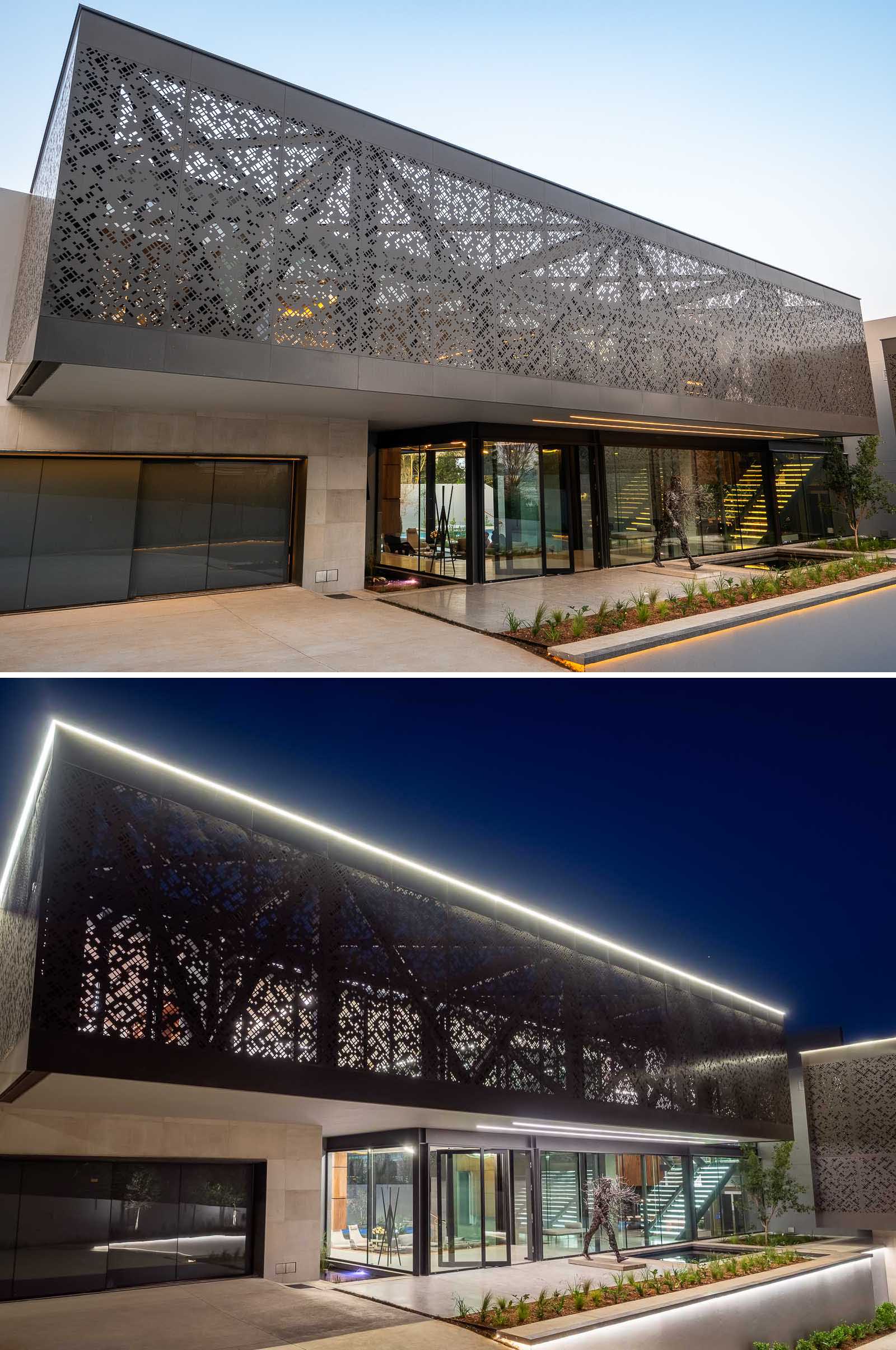 The metal screens, with a perforated pattern, start on the front facade of the home, while the entryway includes multiple water features, a sculpture, and hidden lighting.