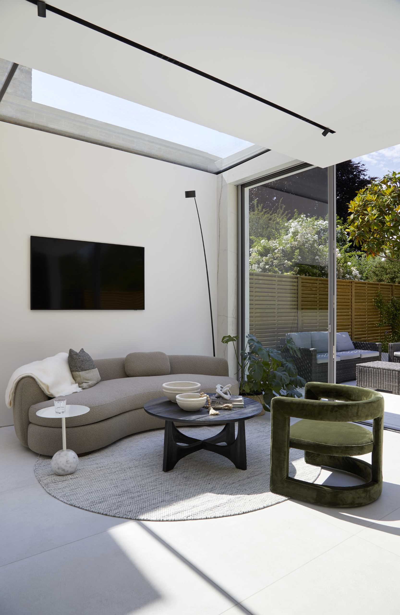 An open plan living area with a skylight, that also opens to the garden.