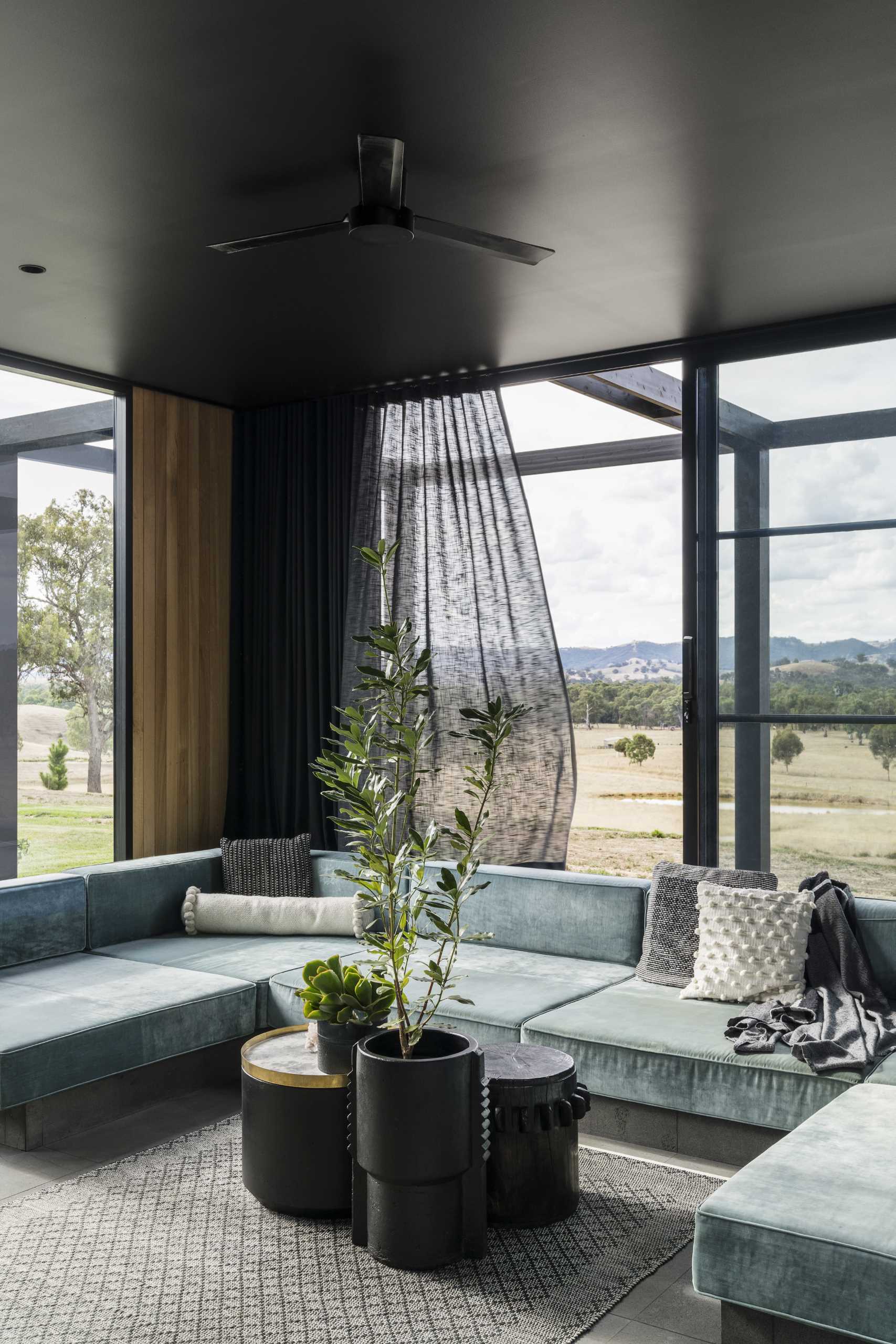 A modern living room with doors that open to the outside.