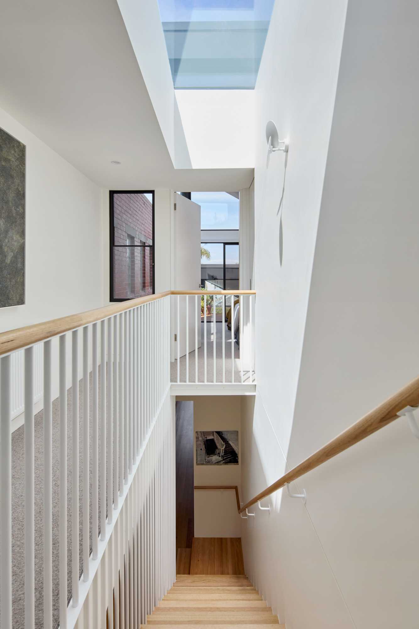 A modern white and wood staircase.