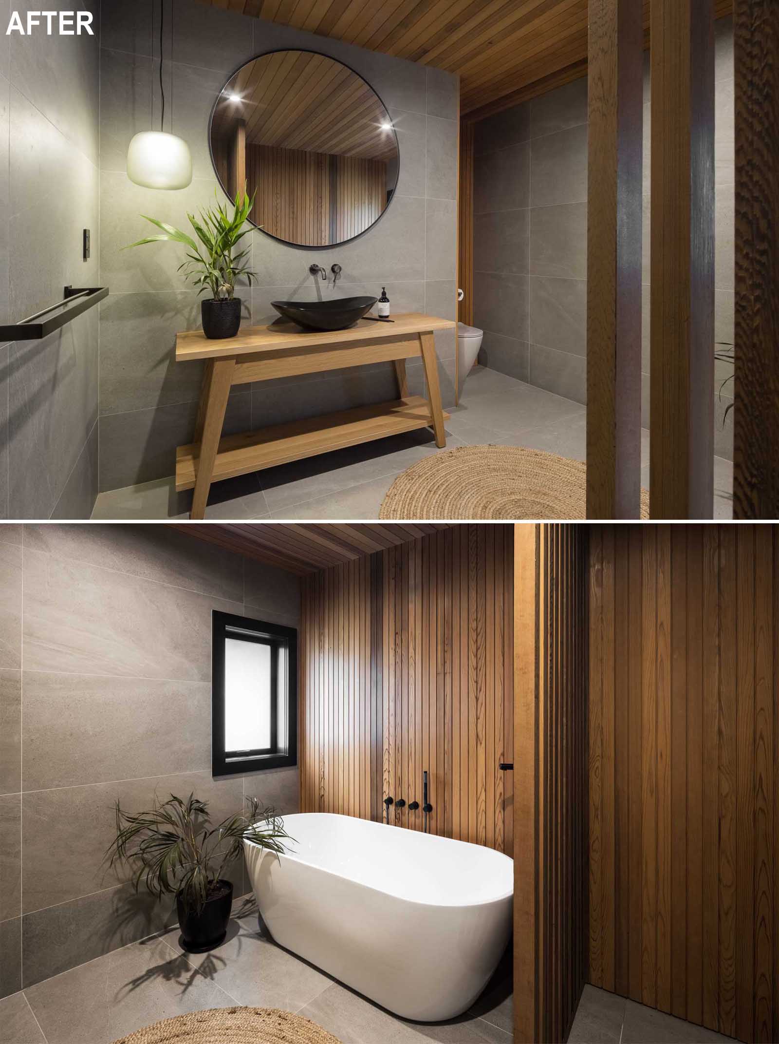 A modern and spa-like bathroom, with natural wood elements, large format tiles, and a freestanding bathtub with wood accent wall.