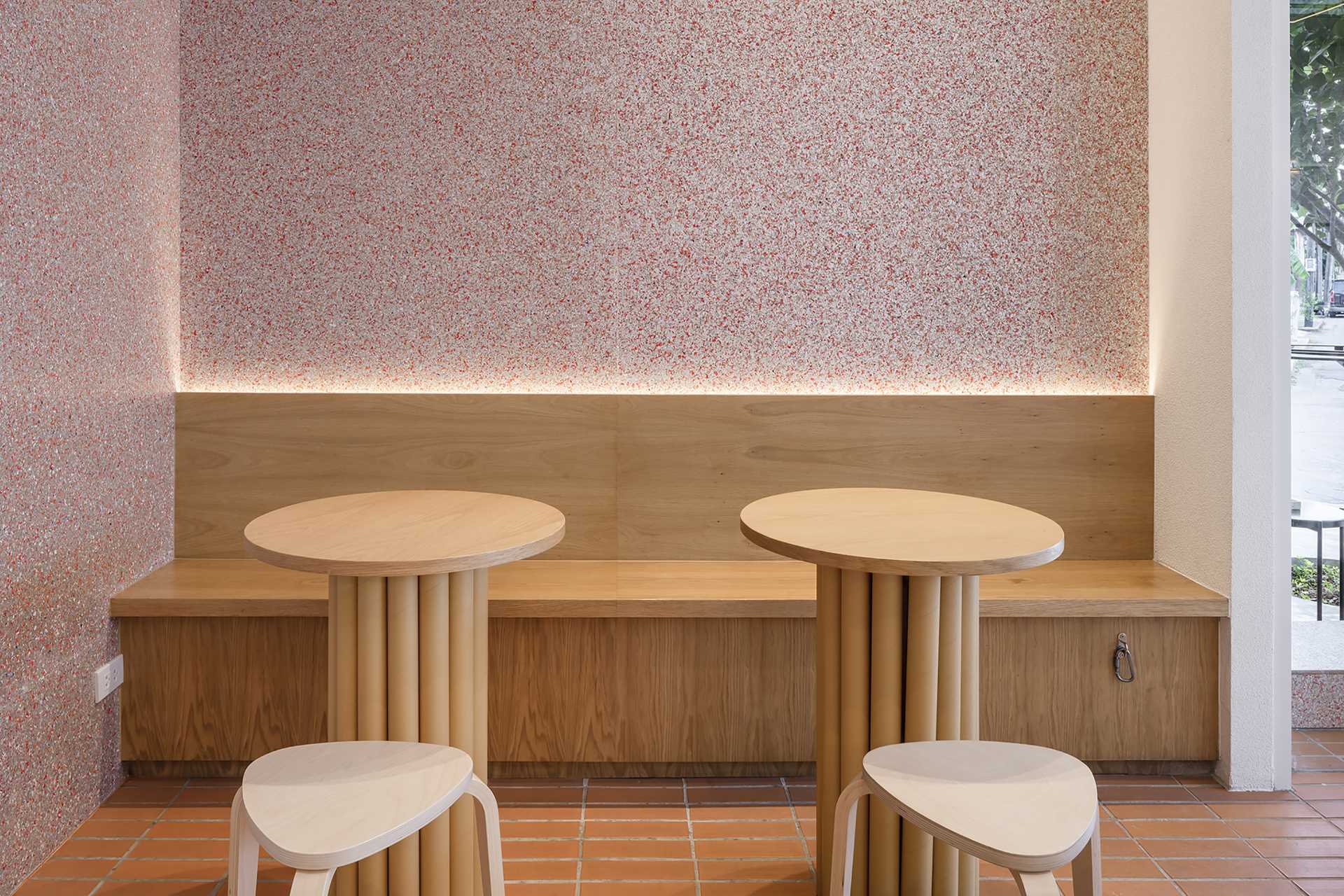 A modern cafe with built-in wood banquette seating.