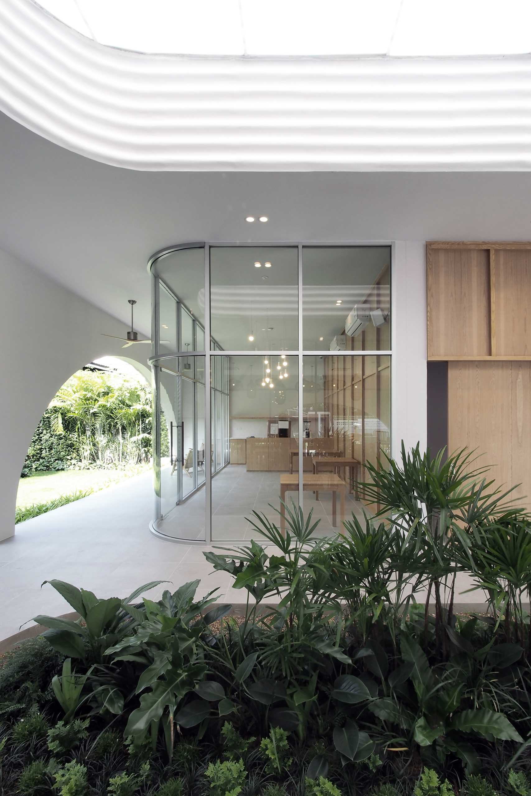 A modern cafe with curved glass windows.