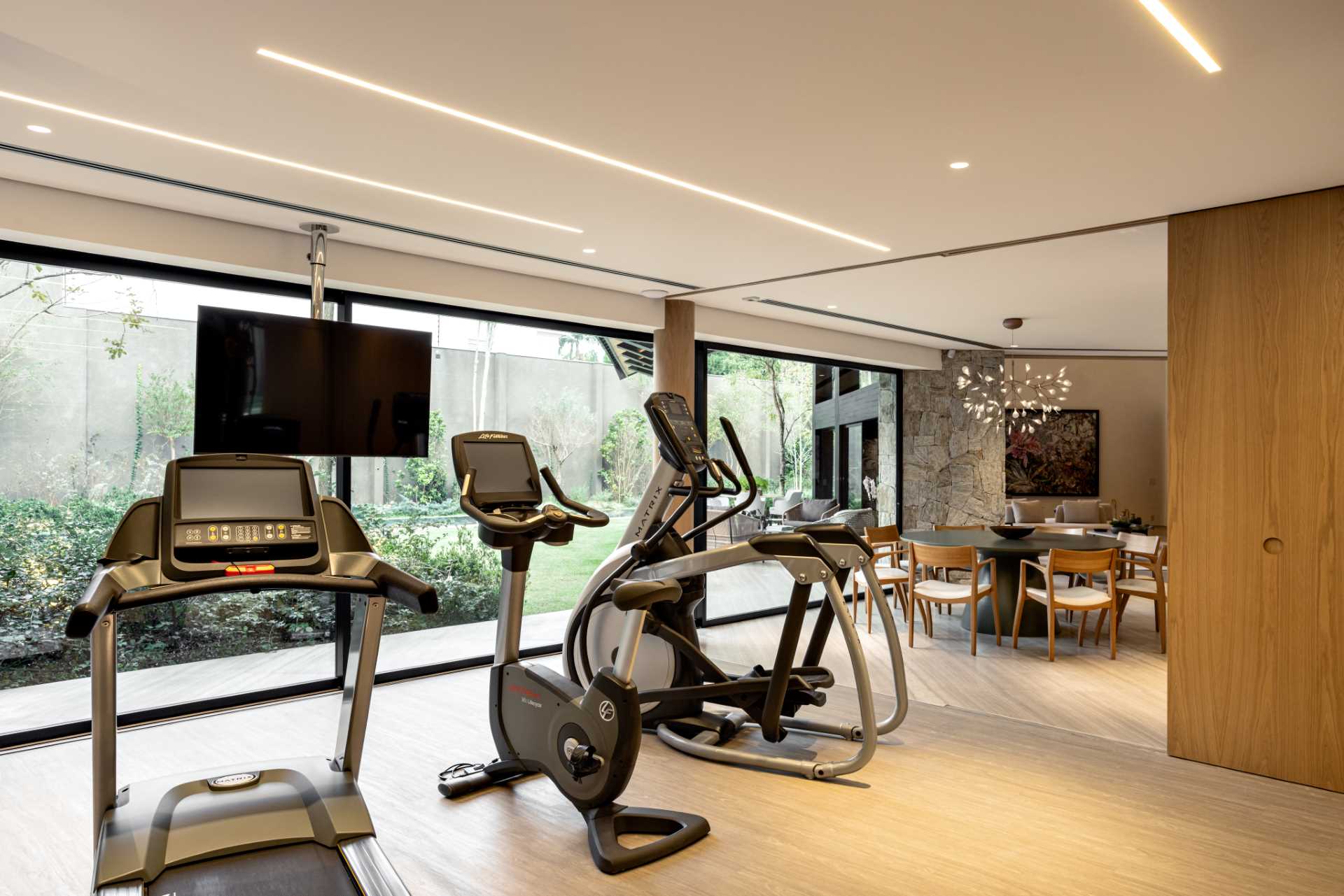 A modern home gym that can hidden from view via a sliding wood wall.