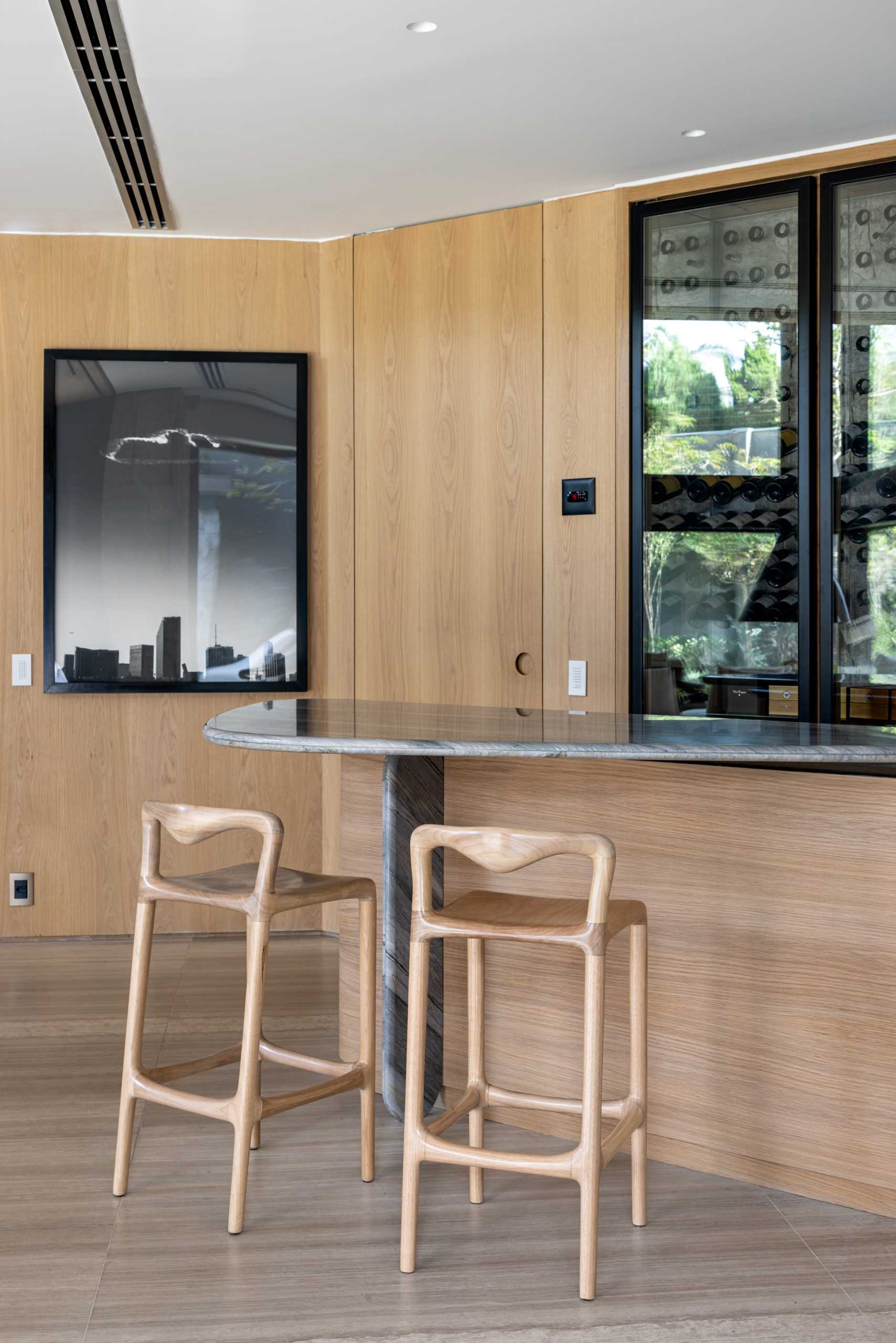 A modern home bar with a large wine fridge.