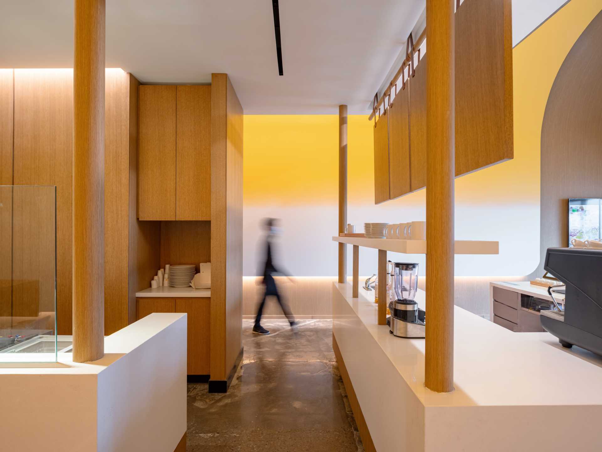 A modern cafe with an exposed kitchen and minimalist serving area.