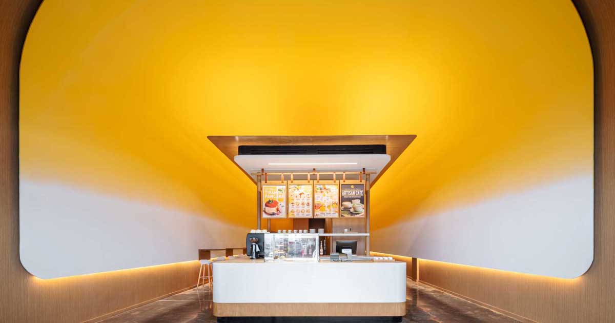 This Pancake Cafe Used A Bold Yellow To Highlight Its Curved Ceiling