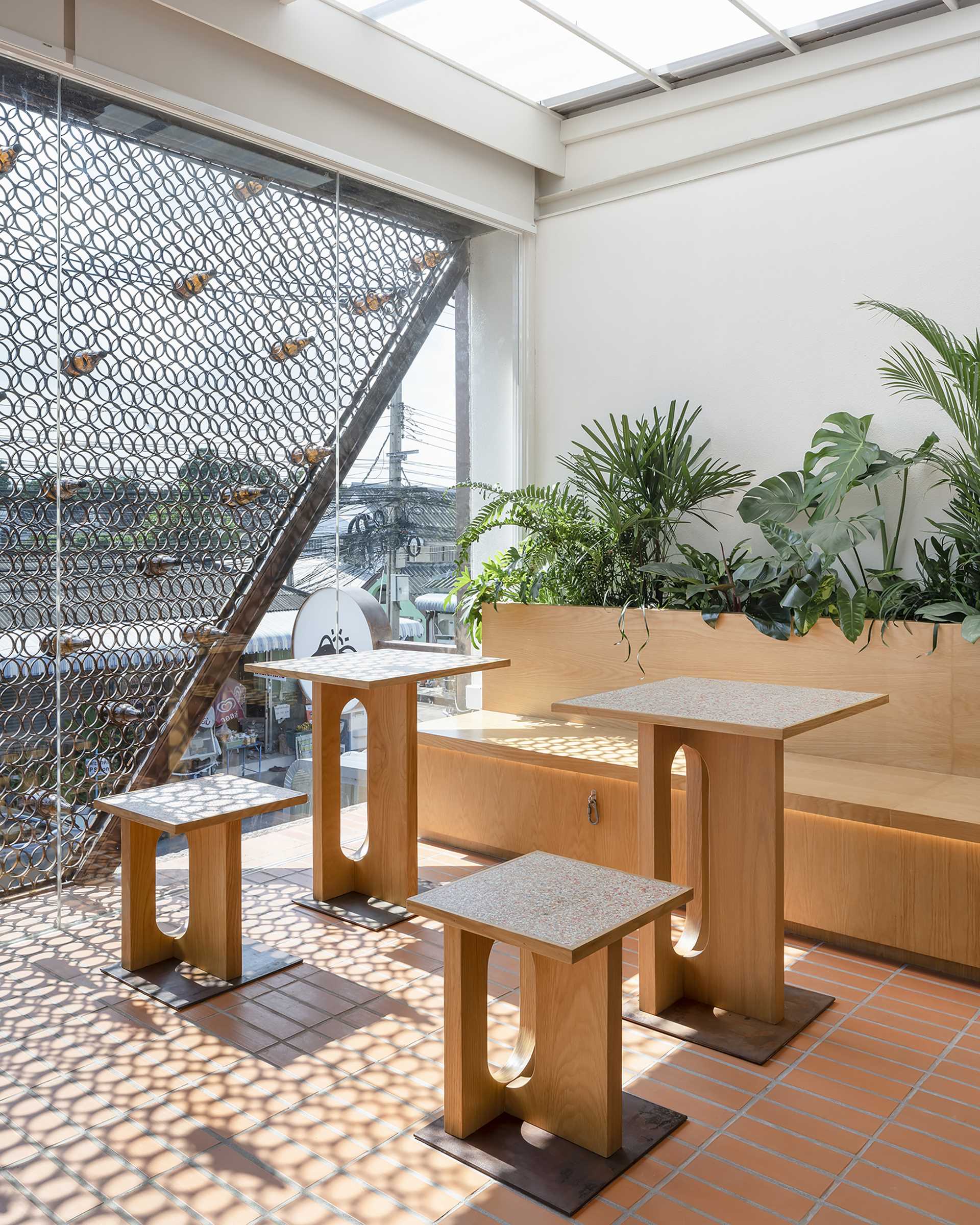 A modern cafe with wood seating and tables.