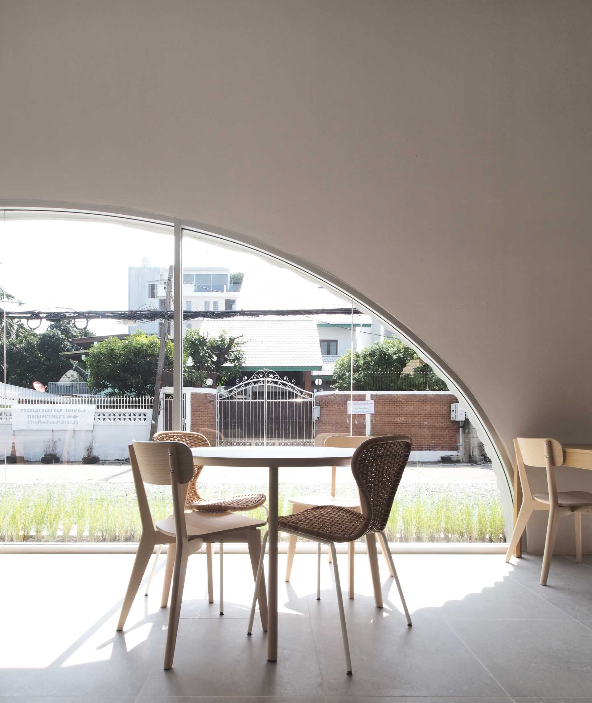 A modern cafe with an arched window.