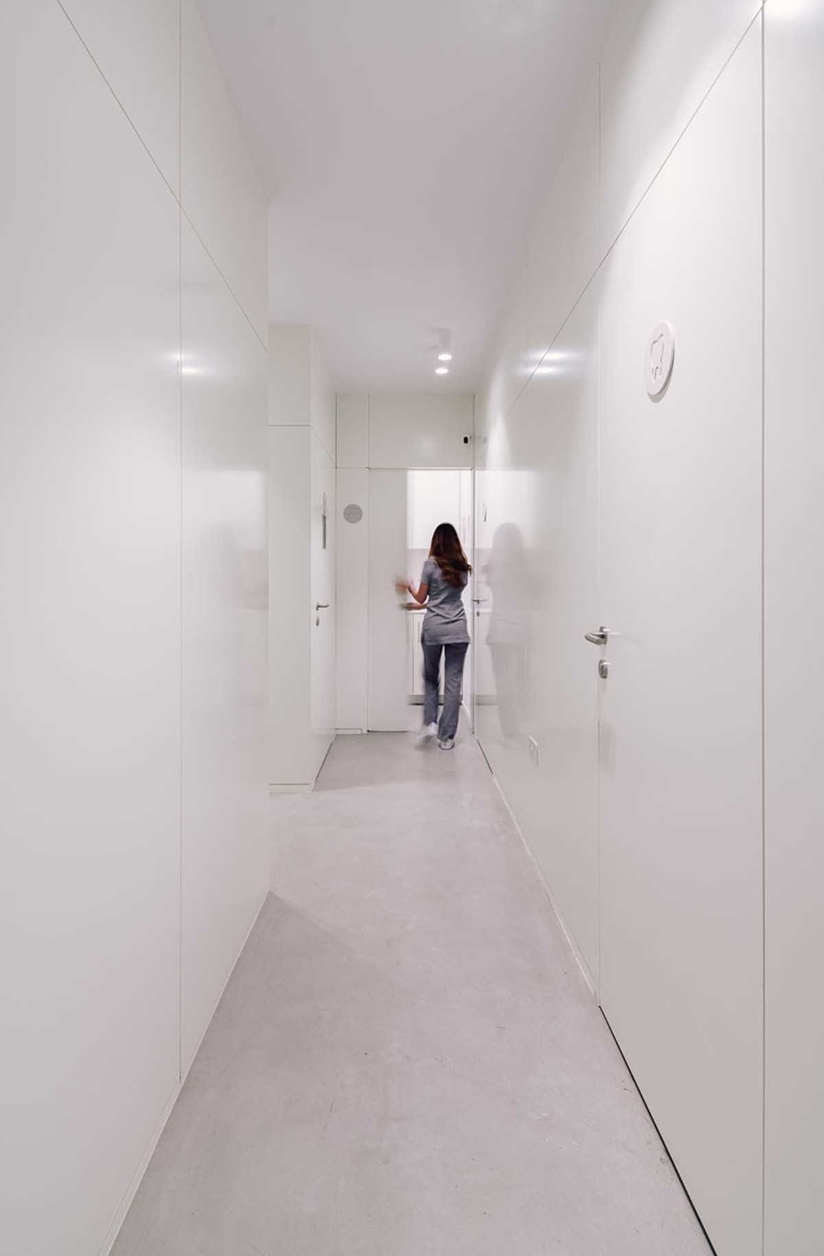 A modern dental clinic hallway with microcement floors.